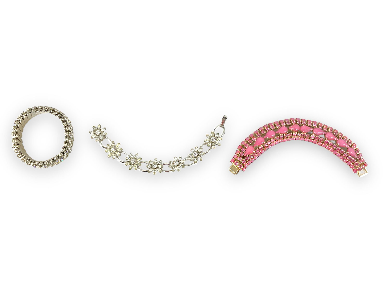 Three Sparkling Bracelets Including One by "Krementz": Three Sparkling Bracelets Including One by "Krementz" First bracelet is hallmarked "Krementz" and is created in silver-tone metal, has seven floral designed rhinestone crystal sections and is 7" long,