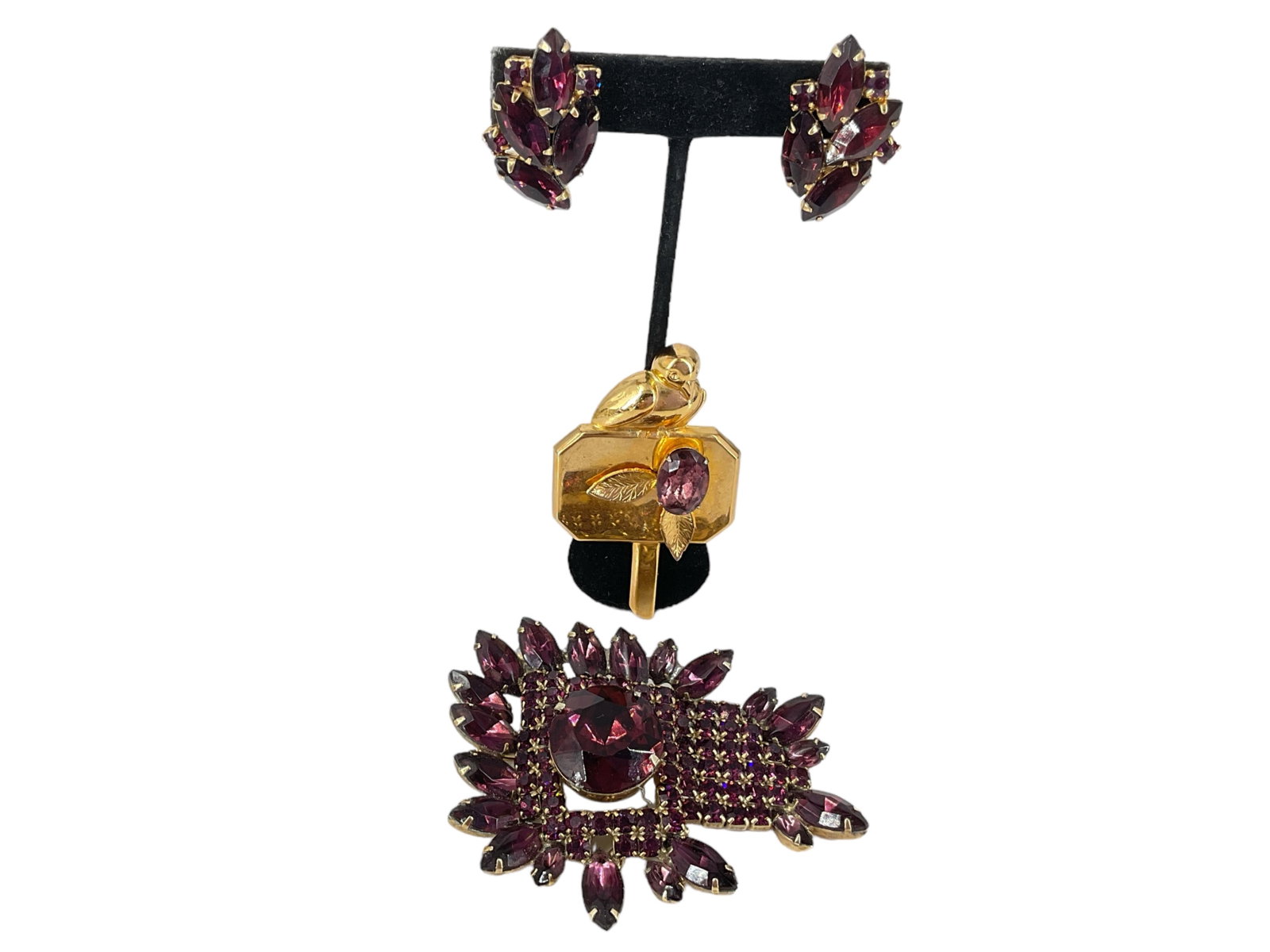 Vintage Purple Fashion Crystal Jewelry: Vintage Purple Fashion Crystal Jewelry Lot includes a free-form brooch in gold-tone metal studded with purple fashion crystals, pin is approx 3" wide and has the matching clip-back earrings @ approx 1