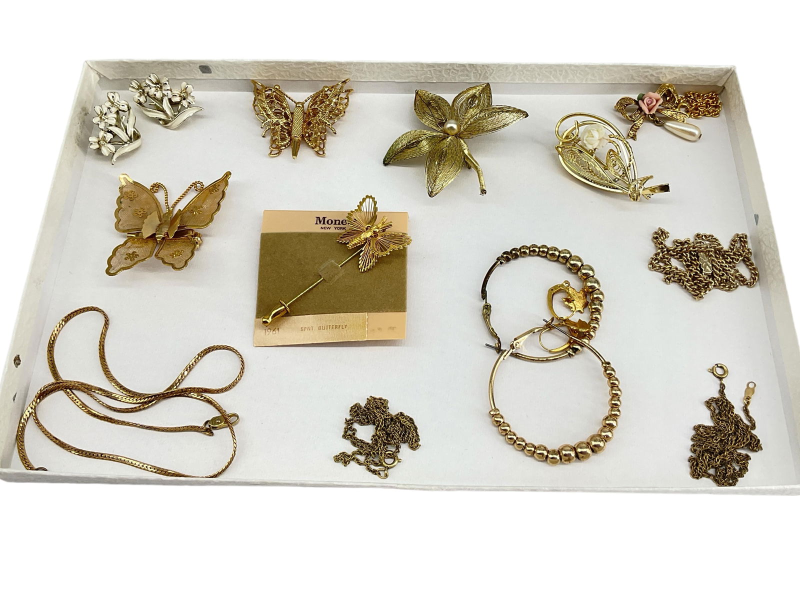 Gold-Tone Fashion Jewelry Including "Monet" and "Coro" Pieces: Gold-Tone Fashion Jewelry Including "Monet" and "Coro" PiecesLot has a mixture of items including a Monet stickpin which is still on the original retail selling card, two butterfly pins with one const