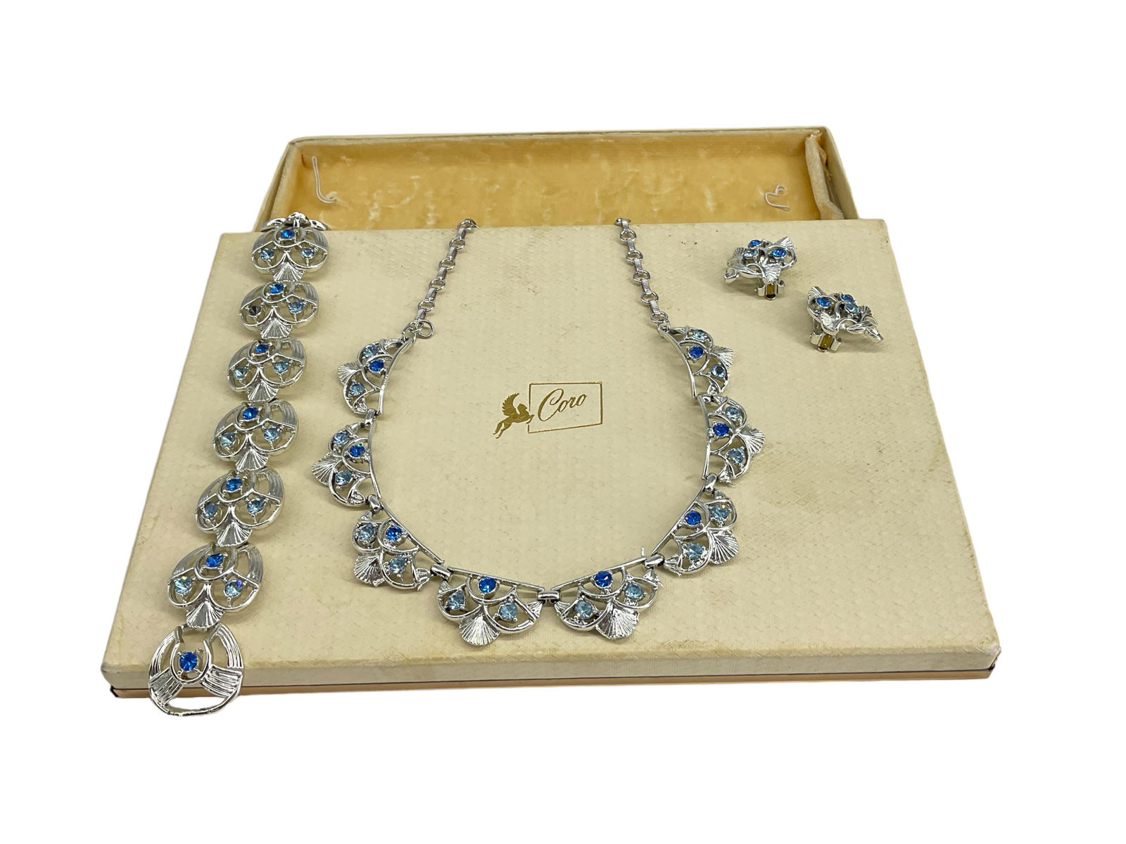 Signed "Coro" Parure in the Original Box: Signed "Coro" Parure in the Original BoxSet is created in silver-tone metal and looks virtually unworn, pieces are in the original vintage "Coro" branded box which is included. Pieces include a bracel
