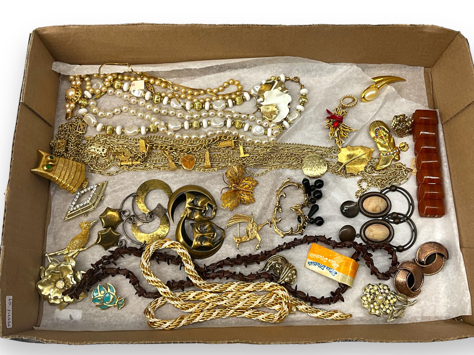 Lot of Gold-Tone Jewelry Including a Pretty Filigree Butterfly Pin: Lot of Gold-Tone Jewelry Including a Pretty Filigree Butterfly Pin Lot has various pieces of vintage fashion jewelry including a chain necklace with locket, faux pearl necklaces, gold-tone pins such a