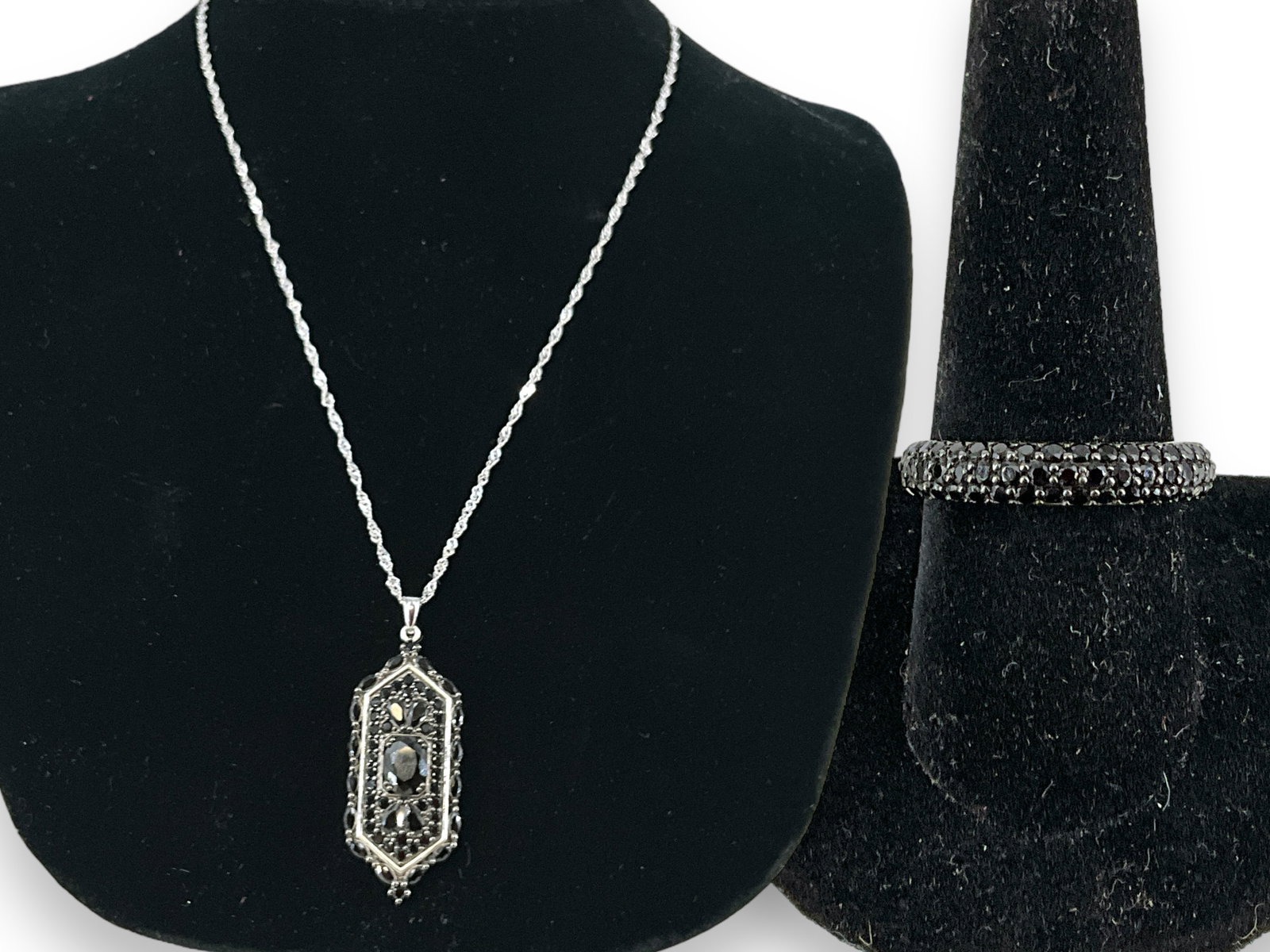 Silver & Onyx Necklace and Ring: Silver & Onyx Necklace and Ring Neck chain is marked and tested silver, is an adjustable 18" long, has a marked and tested silver pendant @ approx 1 1/2" tall having mixed-cut faceted onyx stones. Nec