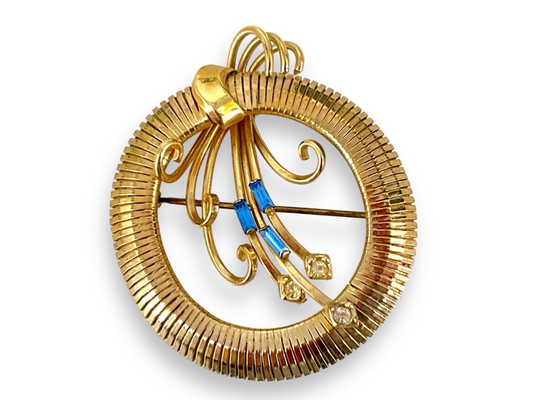 Retro Gold Filled Pin By Regal: Retro Gold Filled Pin By Regal Circular deign measuring (2.07" x 1.75") with a minimalist floral design accented with clear and blue rhinestones 1/20 12kt gold filled, signed on the reverse.