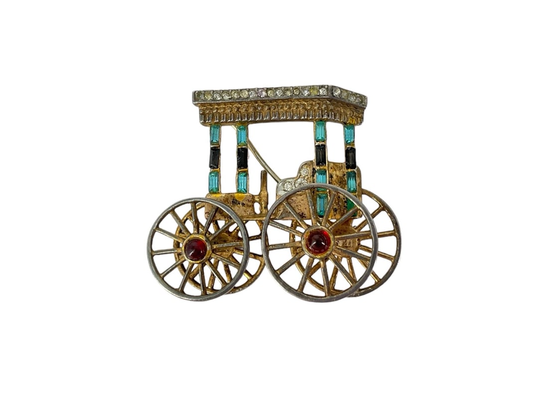 Special Stamped "Trifari" Carriage Brooch w/Moving Wheels Made in Silver: Special Stamped "Trifari" Carriage Brooch w/Moving Wheels Made in Silver Brooch is designed as a carriage which has two moving wheels, has diamantÈ crystal accents, is approx 1" tall and is stamped o
