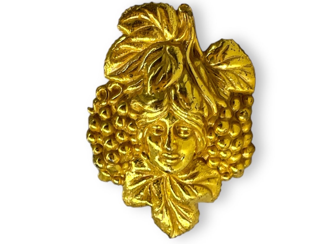 Gold Tone Brooch From Miriam Haskell: Gold Tone Brooch From Miriam HaskellMeasuring approx. (1.95" x 1.35") embossed design featuring a women surrounded by grape bunches and leaves, signed on the reverse.