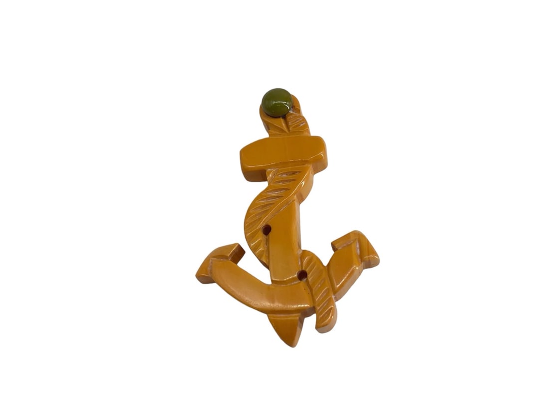 Bakelite Anchor Pin: Bakelite Anchor PinMeasuring (2.71 x 1.8") openwork yellow anchor with green accent at the top.