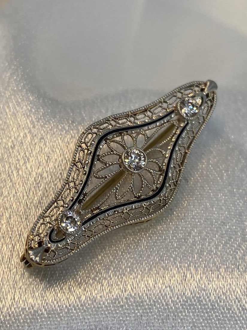 14kt Gold and Diamonds Filigree Pin: 14kt Gold and Diamonds Filigree Pin Stamped and tested 14kt gold, filigree design with thin line of black enameling and set with three diamond rounds, diamond measure 2.5mm and 3.0mm in size, diamonds