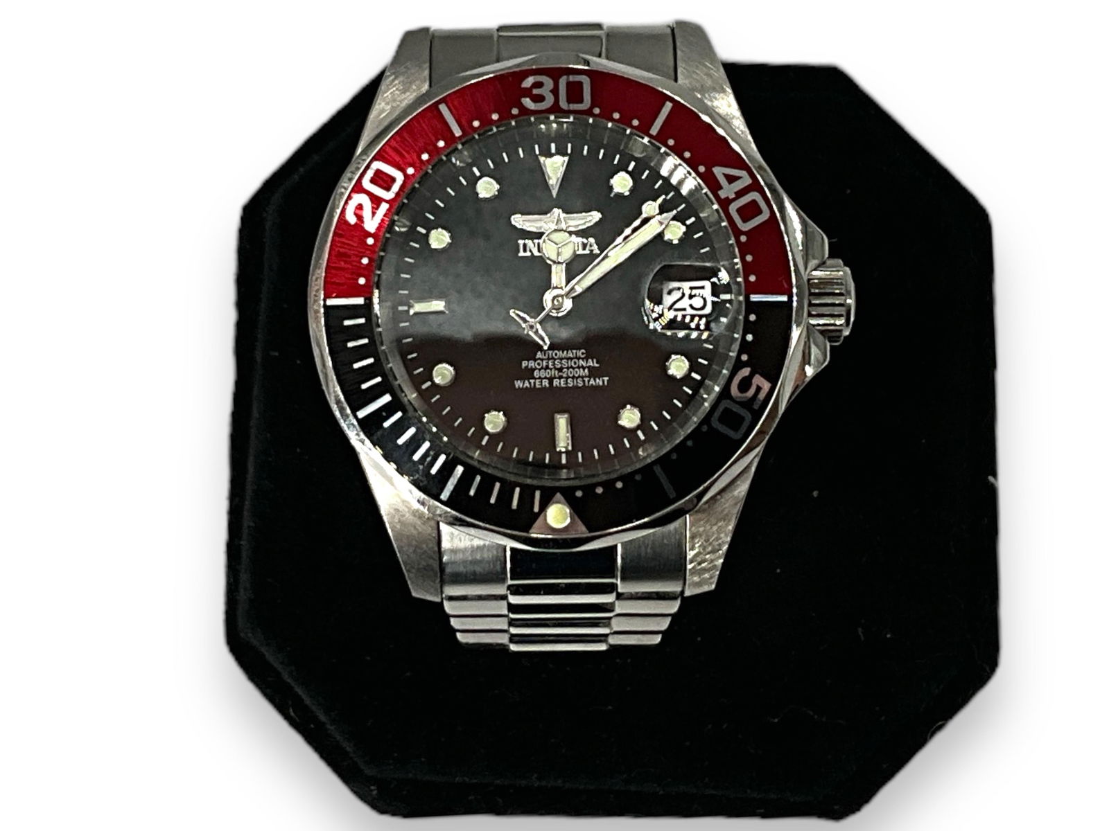 Invicta Pro Divers Wrist Watch: Invicta Pro Divers Wrist WatchStainless steel watch and band, coke bezel, 24 jewel movement, window at the 3 O'clock position, skeleton back, runs at the time of listing, 40mm bezel, model #9403,