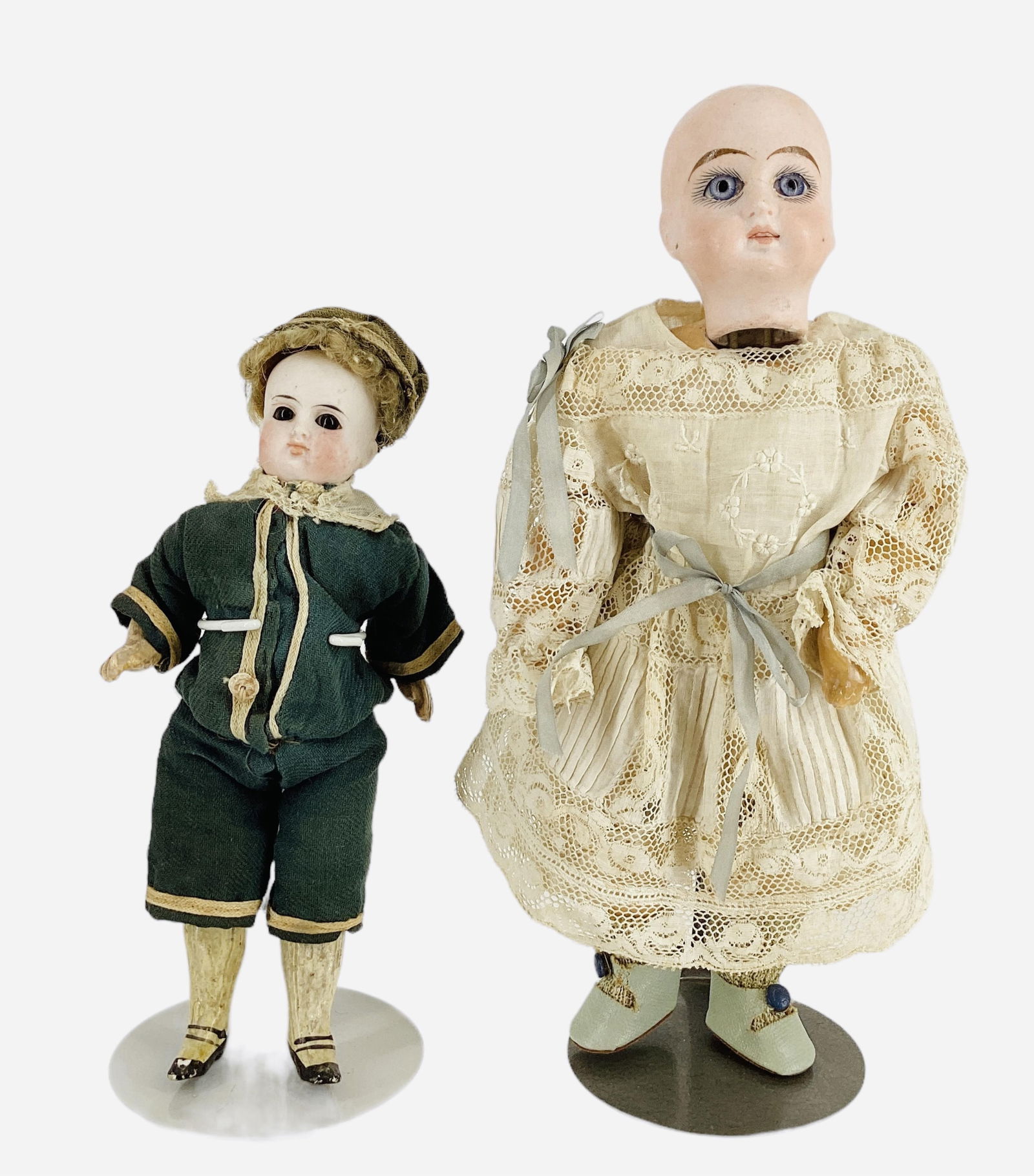 (2) German solid dome bisque head dolls.: (2) German solid dome bisque head dolls.Includes 9" girl with cup and saucer head with two holes used to secure the head to the body, stationary glass eyes, pierced-in ears, open/closed mouth wit