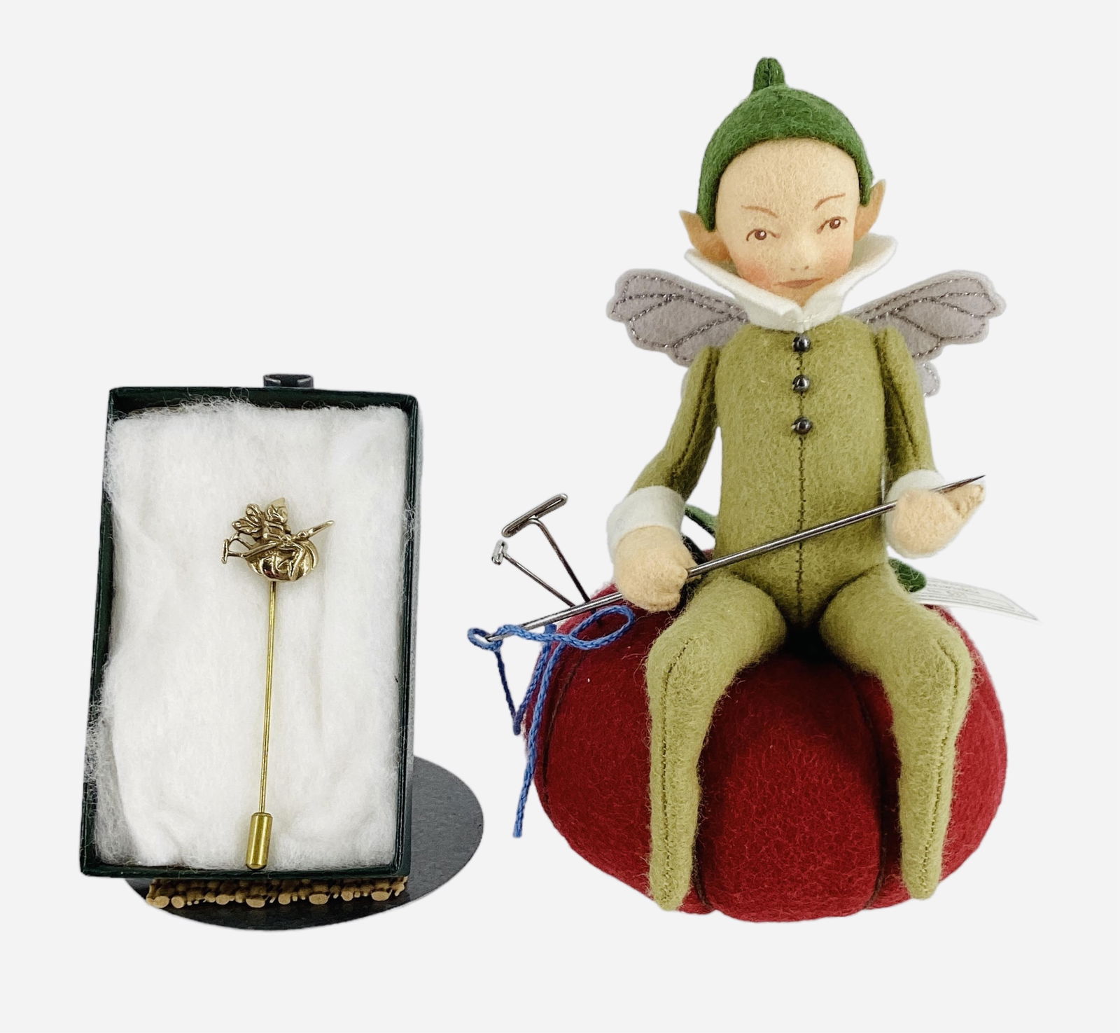 "Periwinkle" by R. John Wright.: "Periwinkle" by R. John Wright.6 1/2" wool felt fairy with molded and painted facial features, applied wings. Periwinkle sits atop a pincushion and holds an oversized needle (careful it