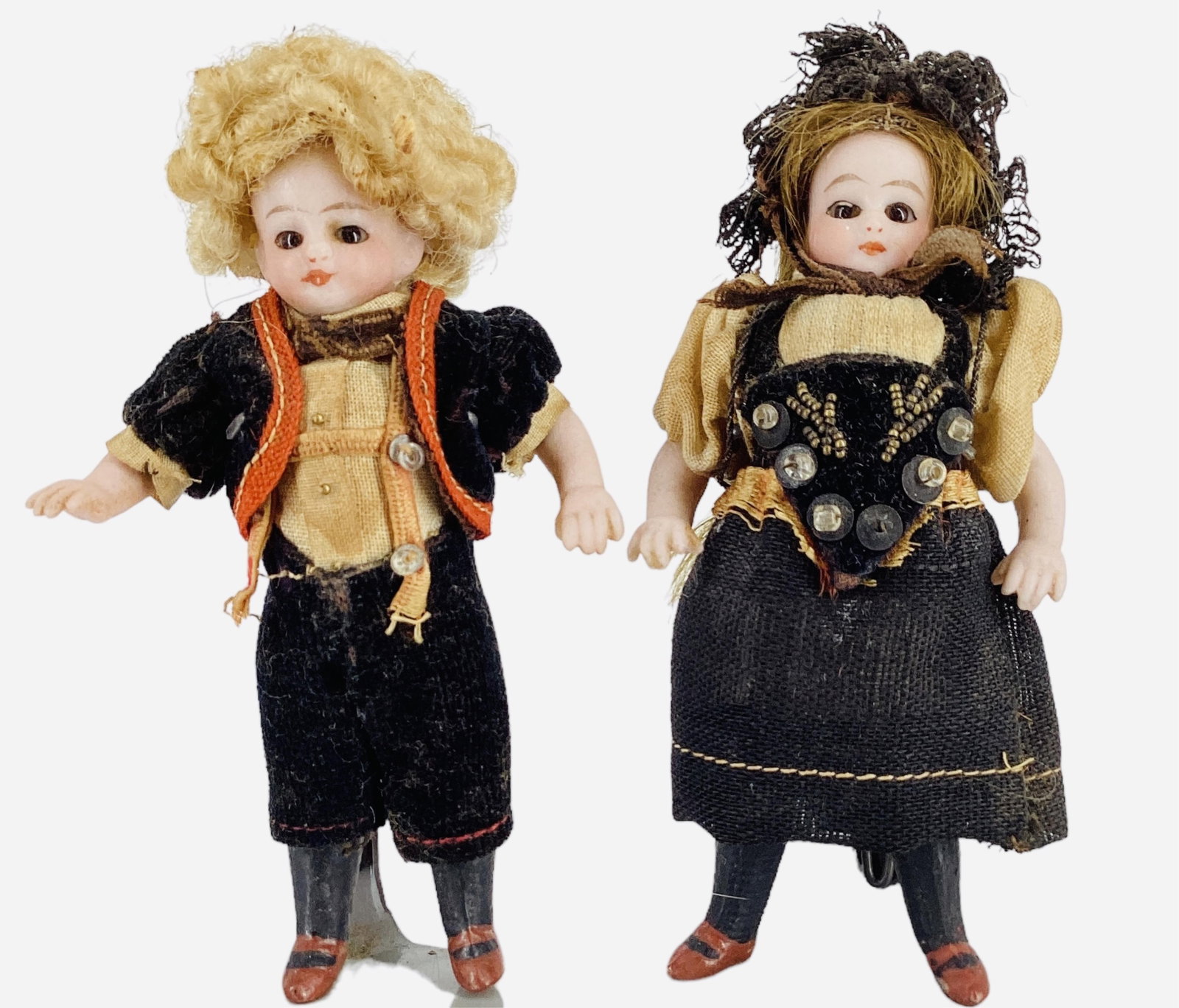Pair All-Bisque Dolls.: Pair All-Bisque Dolls. 3 3/4" dolls with string jointed arms and legs, dressed in regional costumes. Girl has human hair, stationary glass eyes, closed mouth, molded and painted shoes and stockin