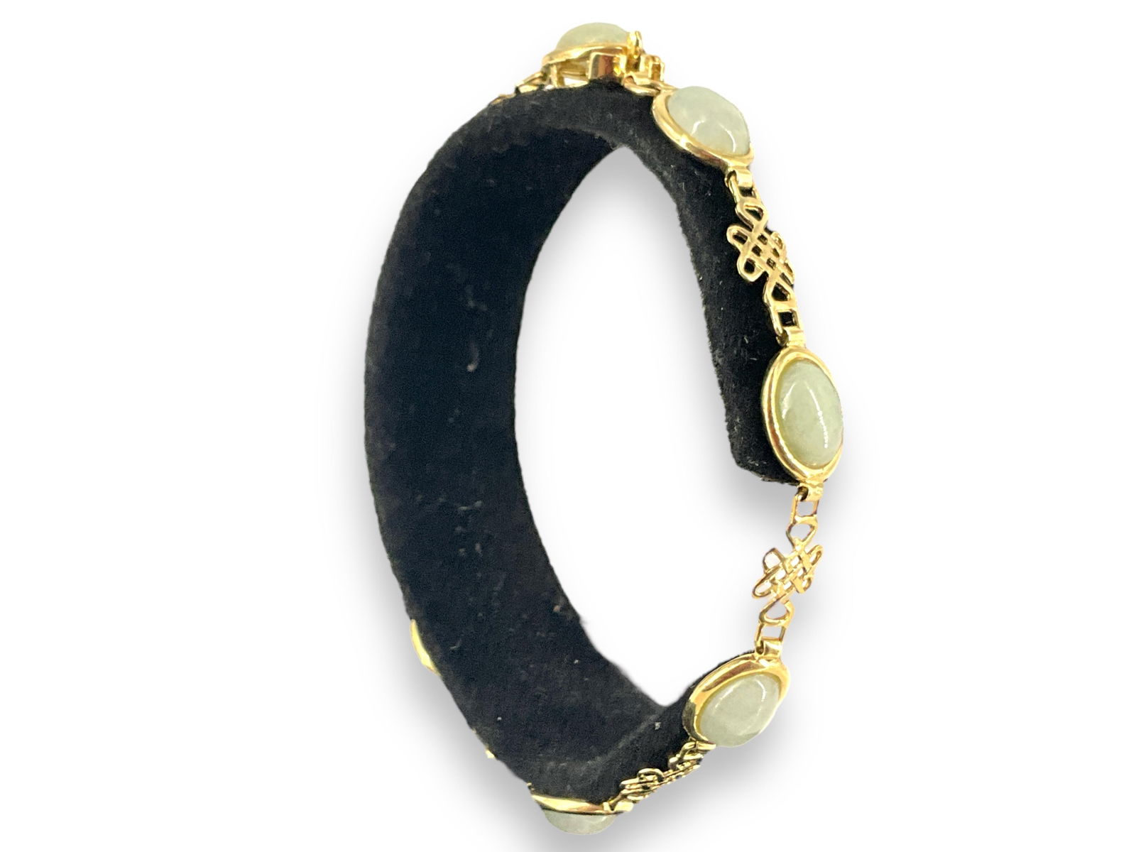 14kt Yellow Gold Jade Bracelet: 14kt Yellow Gold Jade BraceletMeasuring (7.5") in length with polsihed jade cabochons (8.1mm x 6.1mm) alternating with openwork links stamped and tested with box clasp closure (6.5 grams tw).