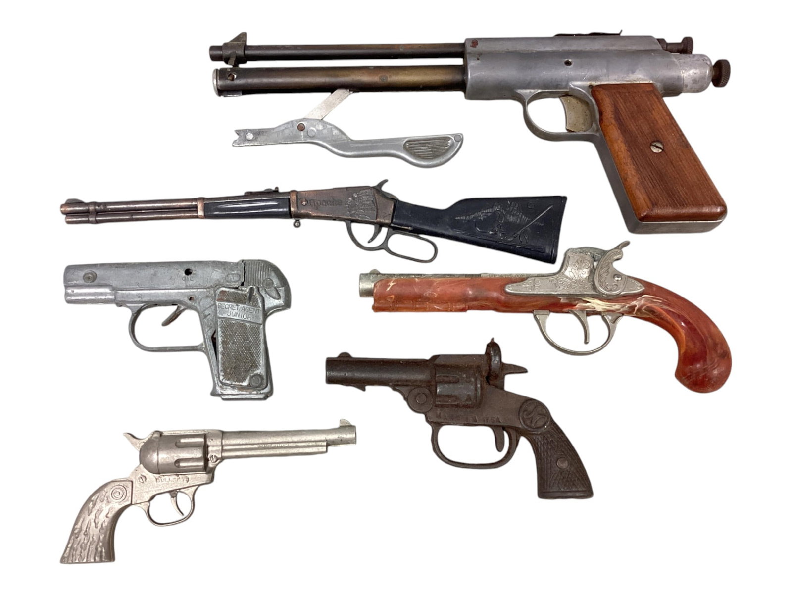 (6) Toy Guns Including a National Cast Iron Cap Gun: (6) Toy Guns Including a National Cast Iron Cap Gun The top gun is an air gun it does work but the pump handle has issues