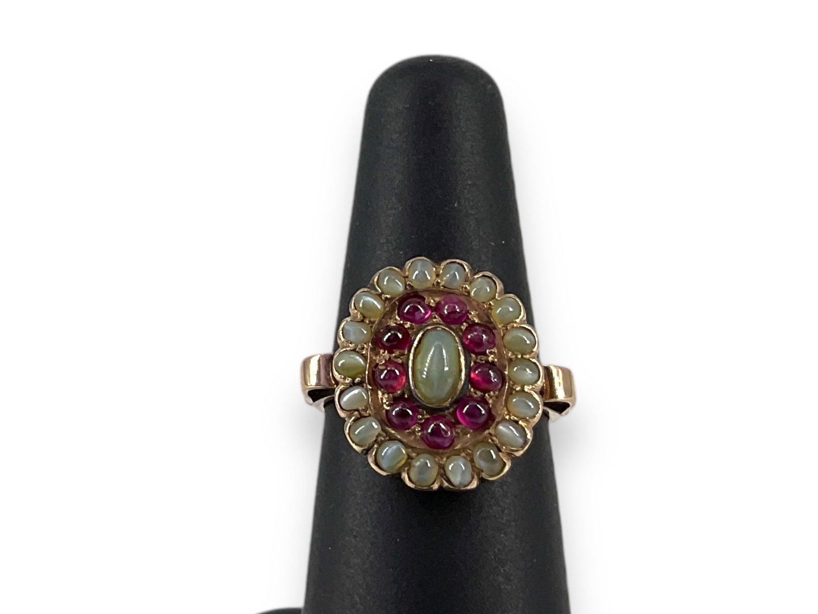 Antique 13K Gold Chrysoberyl Cat's Eye Ruby Ring: Antique 13K Gold Chrysoberyl Cat's Eye Ruby RingThis distinct vintage ring tests 13k yellow gold, has open scrolled shoulders and an oval-shaped top with cabochon cat's eye chrysoberyl stones and smal