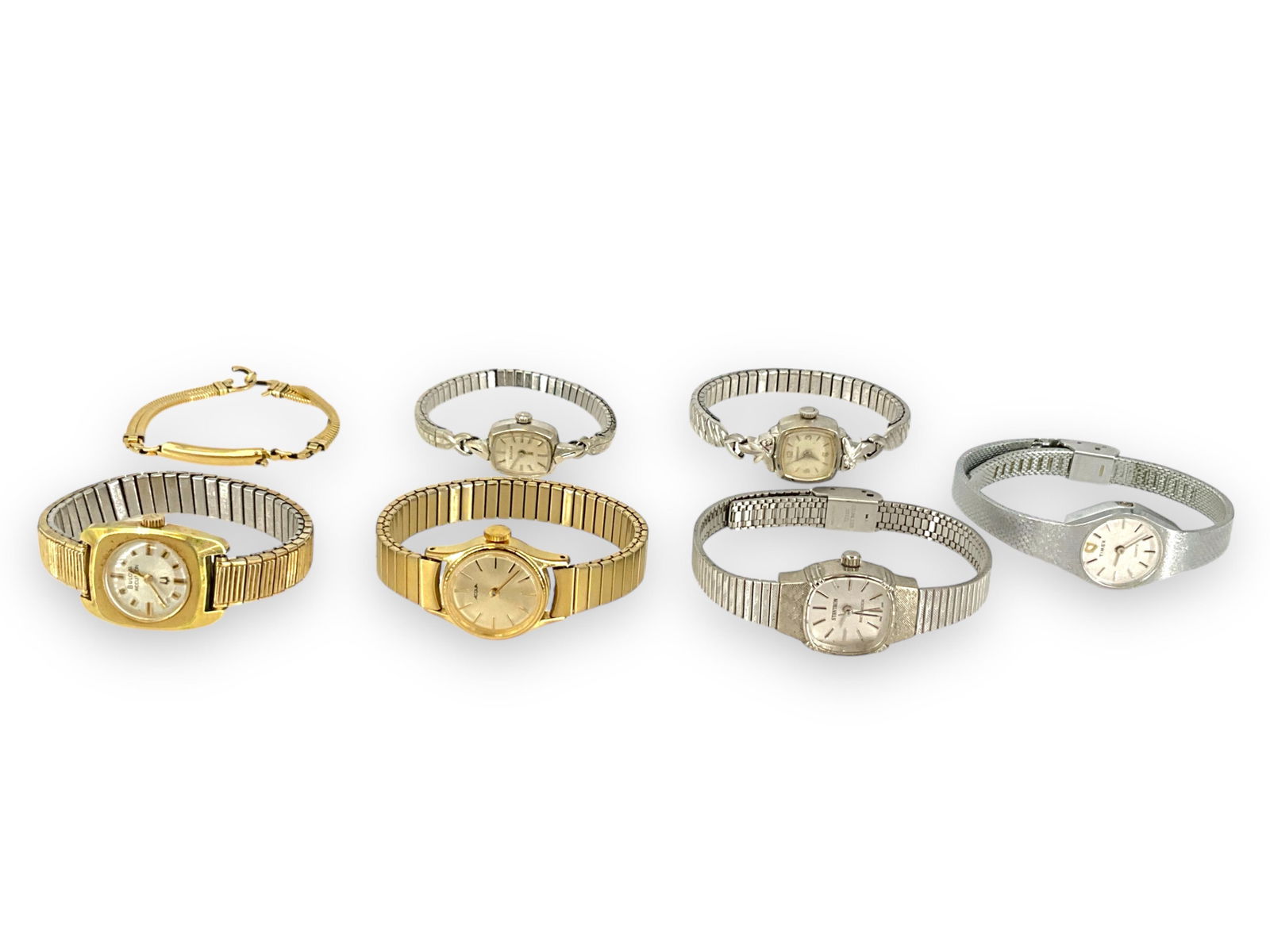 A Collection of Ladies Vintage Watches: A Collection of Ladies Vintage WatchesA collection of six ladies vintage watches (and a gold-tone watchband) begins with the silver-tone pieces including a Timex Quartz K-Cell, a Bulova with a white 1