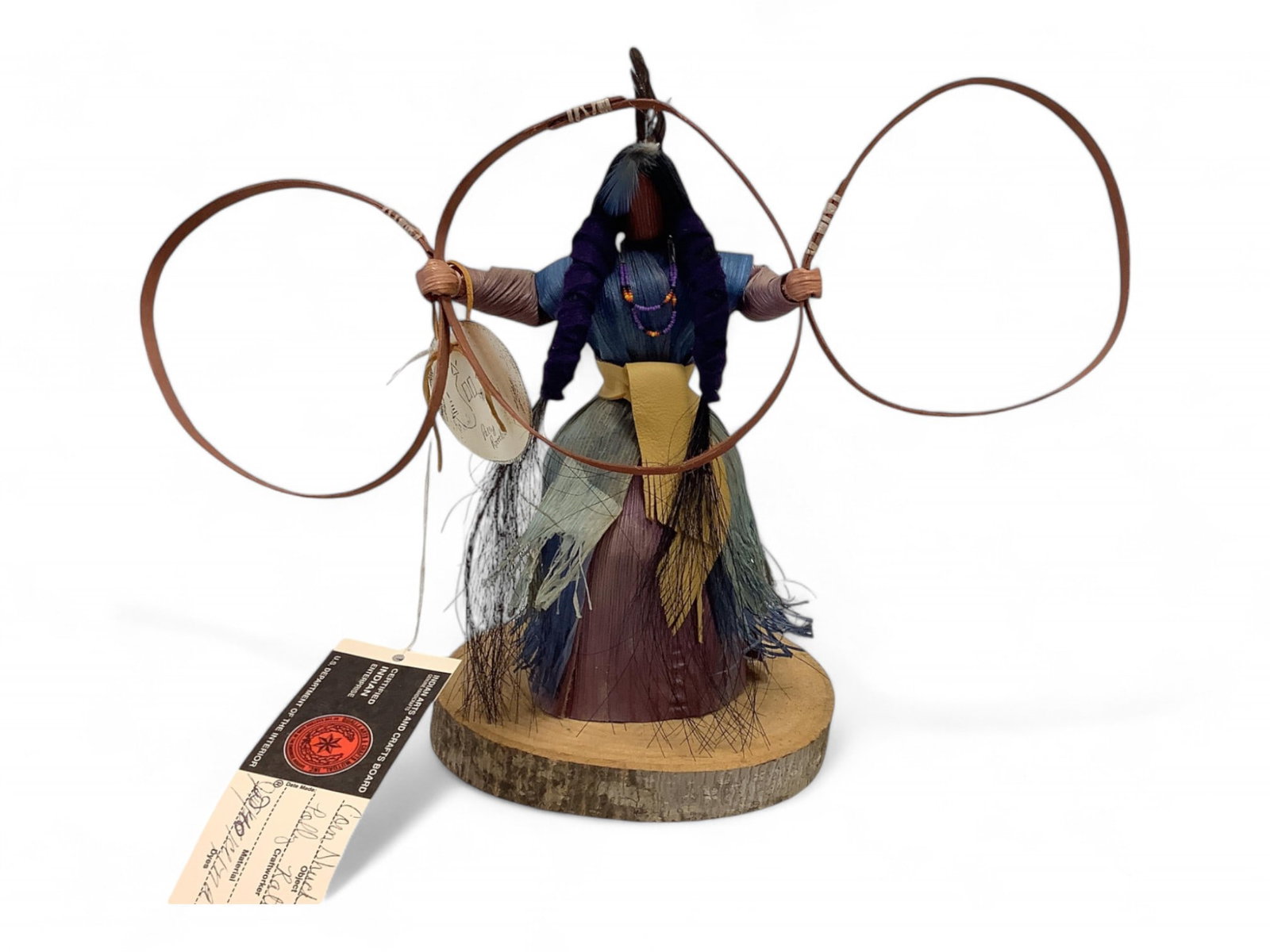 Corn Shuck Hoop Dancer: Corn Shuck Hoop Dancer Cherokee, signed Polly Rattler. 12" tall on 6" x7" wood base. Hoops 15.25" wide.