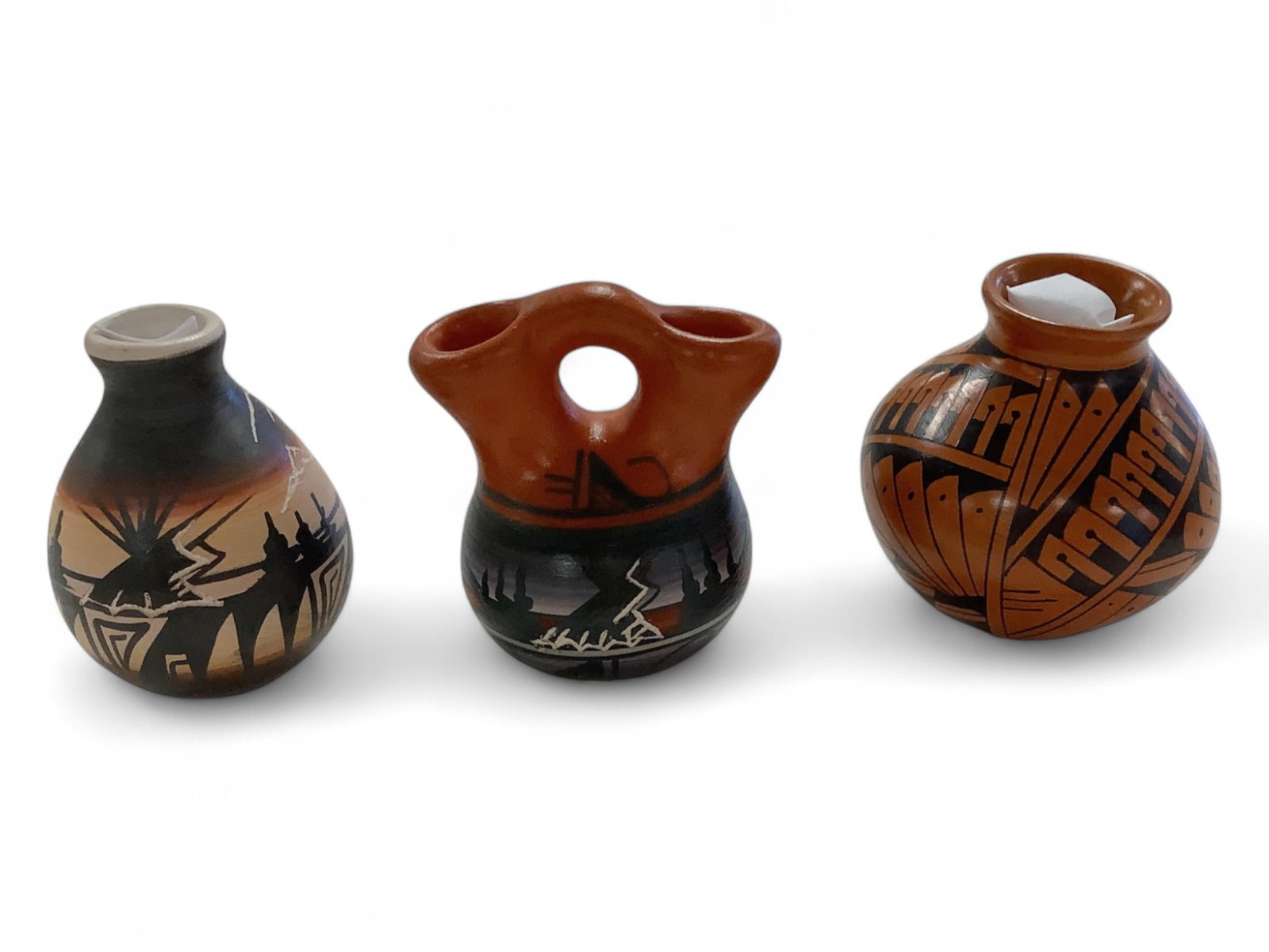 Three American Indian Pieces of Pottery: Three American Indian Pieces of Pottery Three pieces of American Indian pottery all around 2.5"H. There is a Navajo Wedding Jar with a double spout and a Navajo Vase with a single opening. Also in the