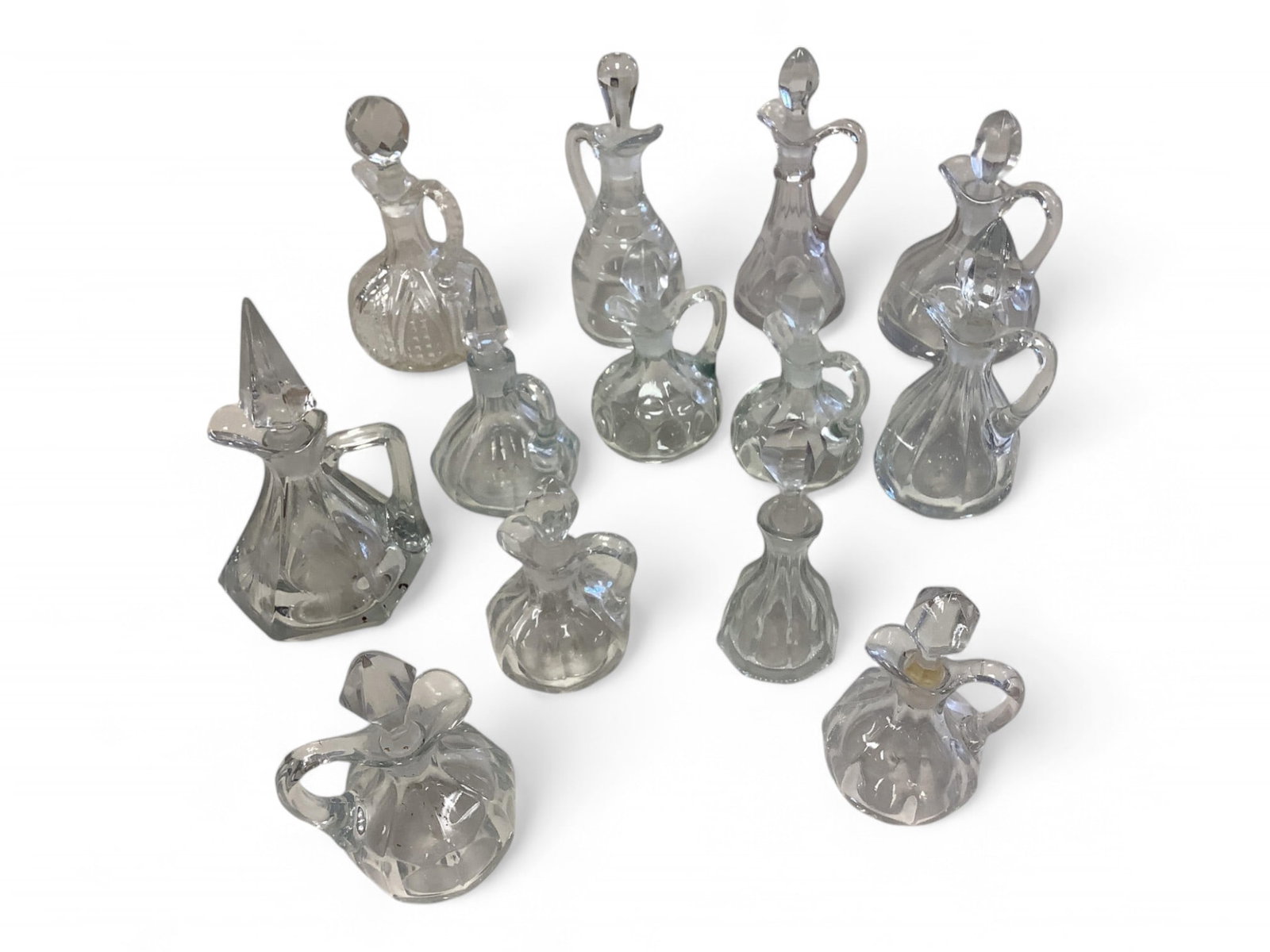 Heisey Cruets: Heisey Cruets Pair of Puritan 2.5 oz .. Saturn 6 oz with correct stopper. Fancy loop 6 oz with faceted stopper. Plain panel recess 6" faceted flowers and leaves cutting. Flat panel 6 oz with incorrect