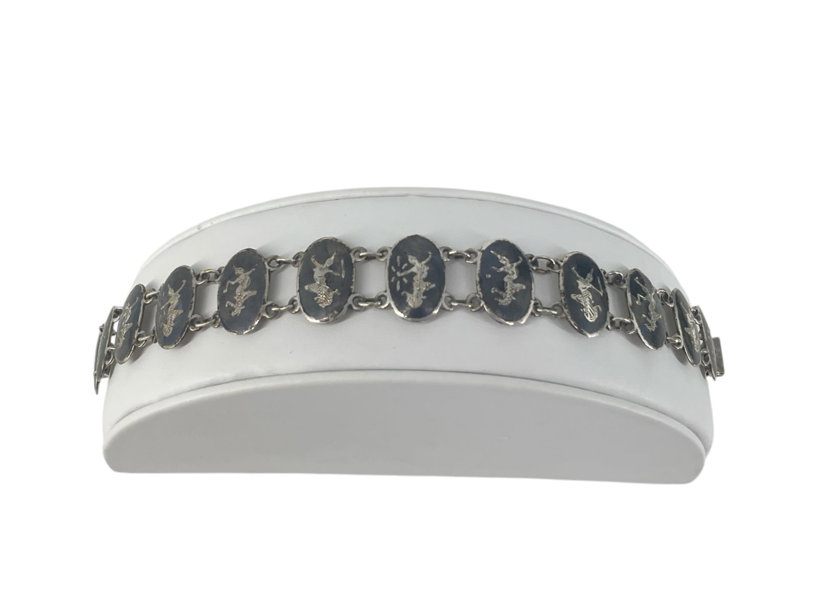 Siamese Sterling Silver Bracelet: Siamese Sterling Silver Bracelet Stamped and tested sterling silver/925, 0.445 troy ounces total weight, 7.25" in length, 16mm in width, traditional nielloware design.