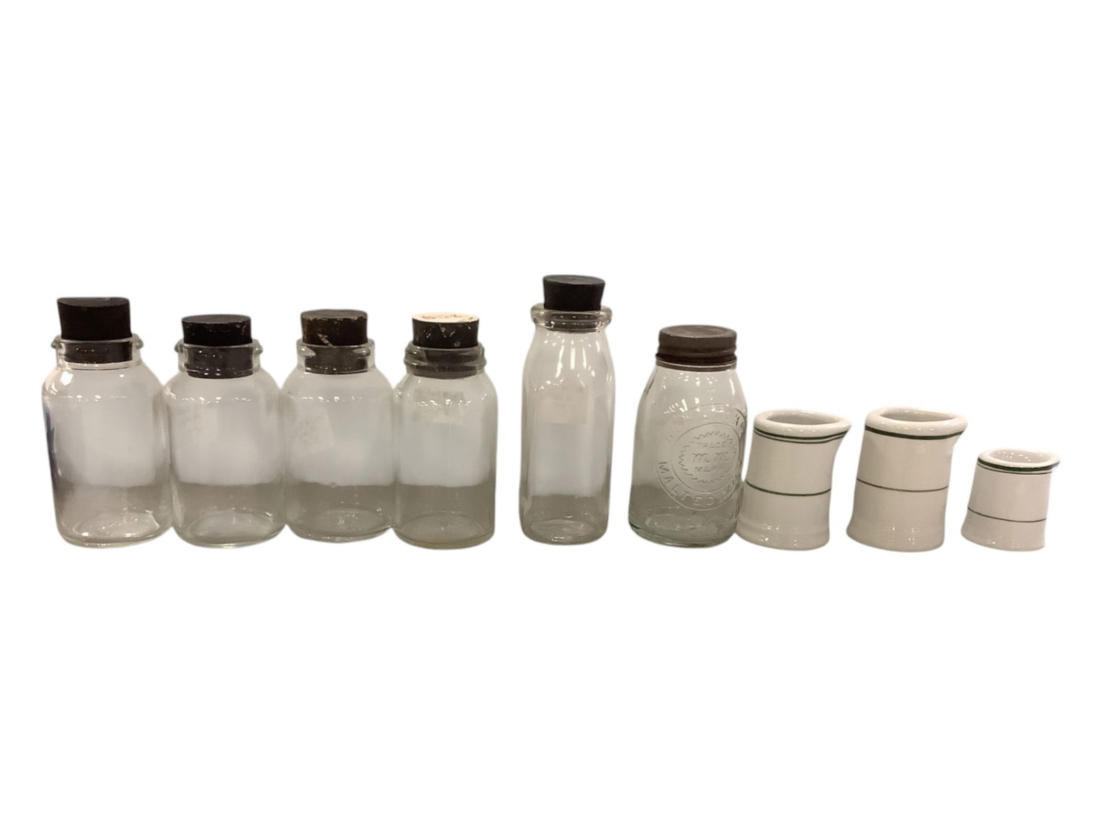 Six Bottles with Tops and Three Cream Pitchers 3" to 6" tall. (1 of 2)