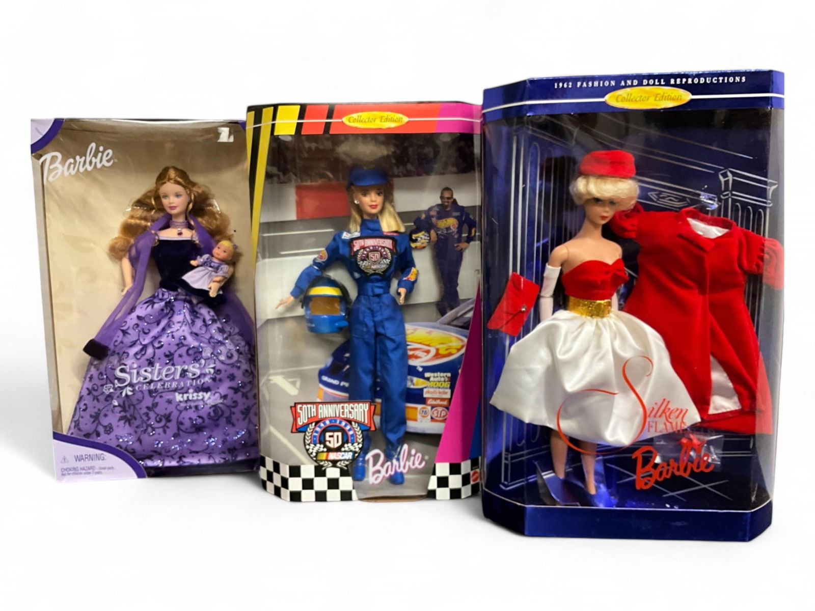 (3) Barbies including Reproduction: (3) Barbies including Reproduction1962 Fashion and Doll Reproduction Silken Flame Barbie 1844950th Anniversary NASCAR 20442Sisters Celebration Krissy, Baby Sister of Barbie 27148