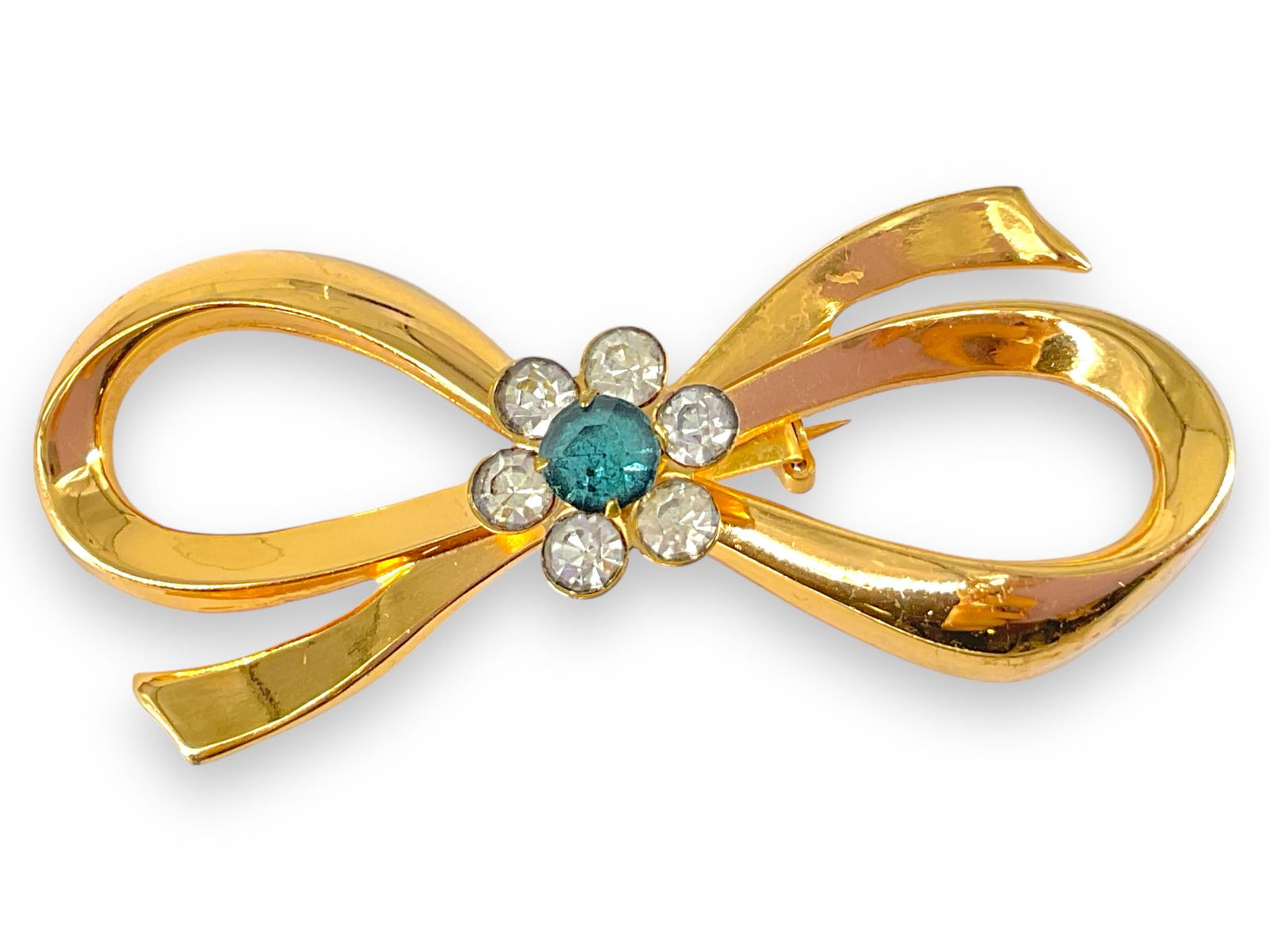 Coro Brooch: Coro BroochBow motif, signed on reverse, gold tone - base metal, adorned with crystal accents, minor age-related wear, approximately 67.0mm in size.