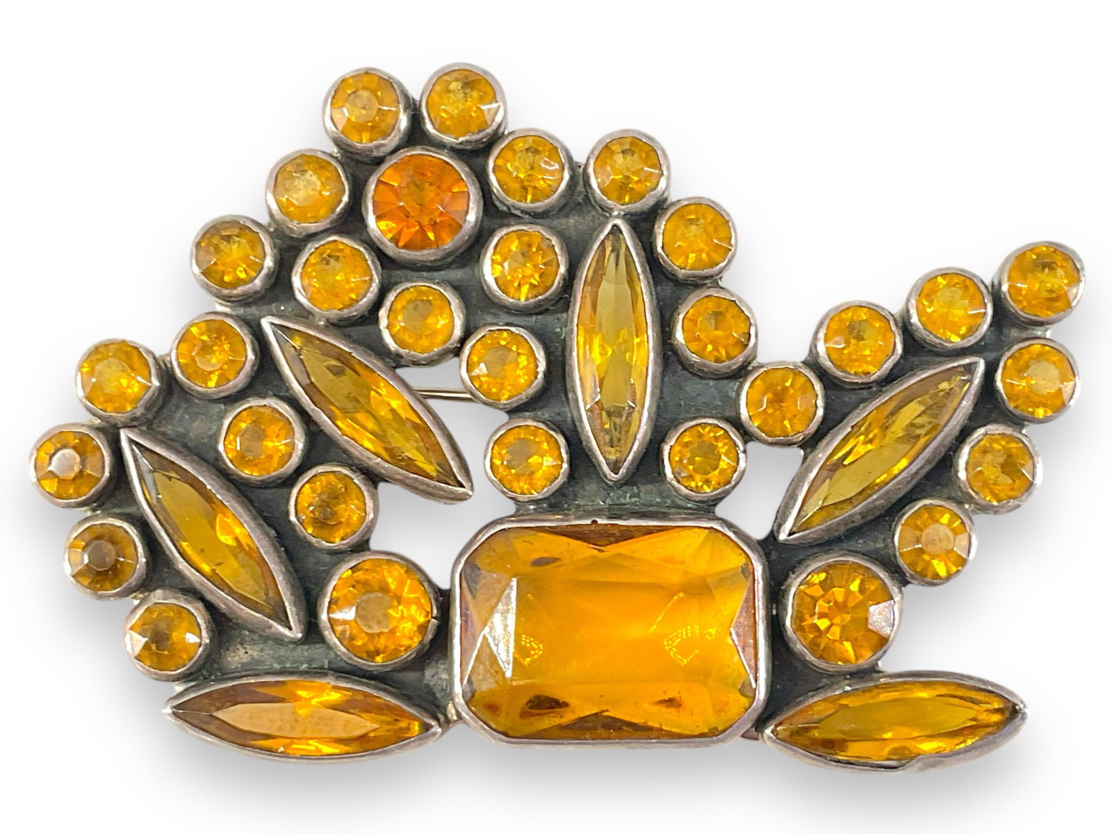 Sterling Silver and Crystals Pin: Sterling Silver and Crystals Pin Stamped, tested and signed. 0.93 troy ounces total weight, 63.5mm in width, set with citrine-colored crystals in various faceted shapes measuring up to 17.5mm in size 