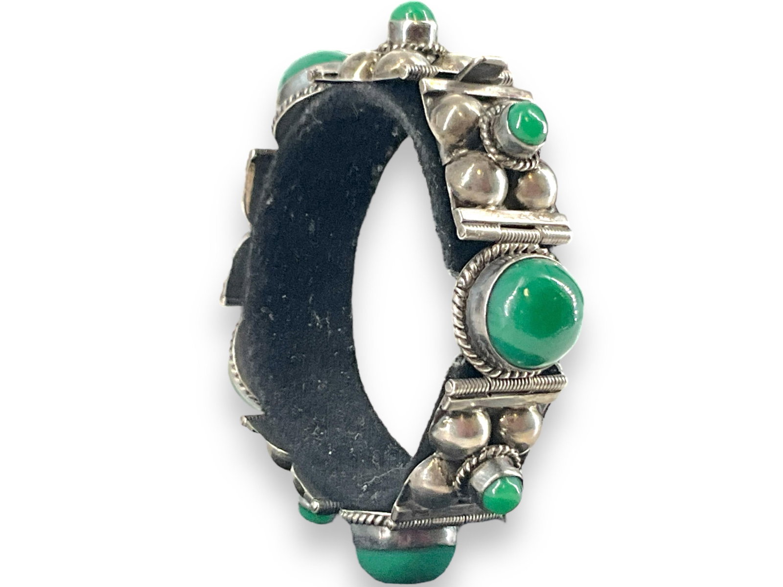 Vintage Silver Bracelet w/Green Onyx Decoration: Vintage Silver Bracelet w/Green Onyx Decoration This vintage bracelet is tested as silver and stamped "Sterling Mexico" - has hinged sections with green onyx accents and is approx 7" long, 1/2" wide. 