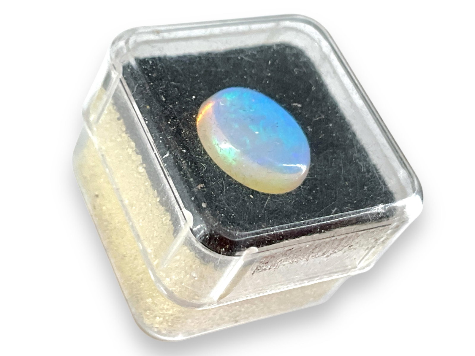 Opal Stone Cabochon: Opal Stone Cabochon 10mm x 8mm x 3mm in size, no cracks/chips at the time of listing, likely Ethiopian in origin, blue body color (yellow in sunlight) ft. faint green pinfires and a faint orange hue. 