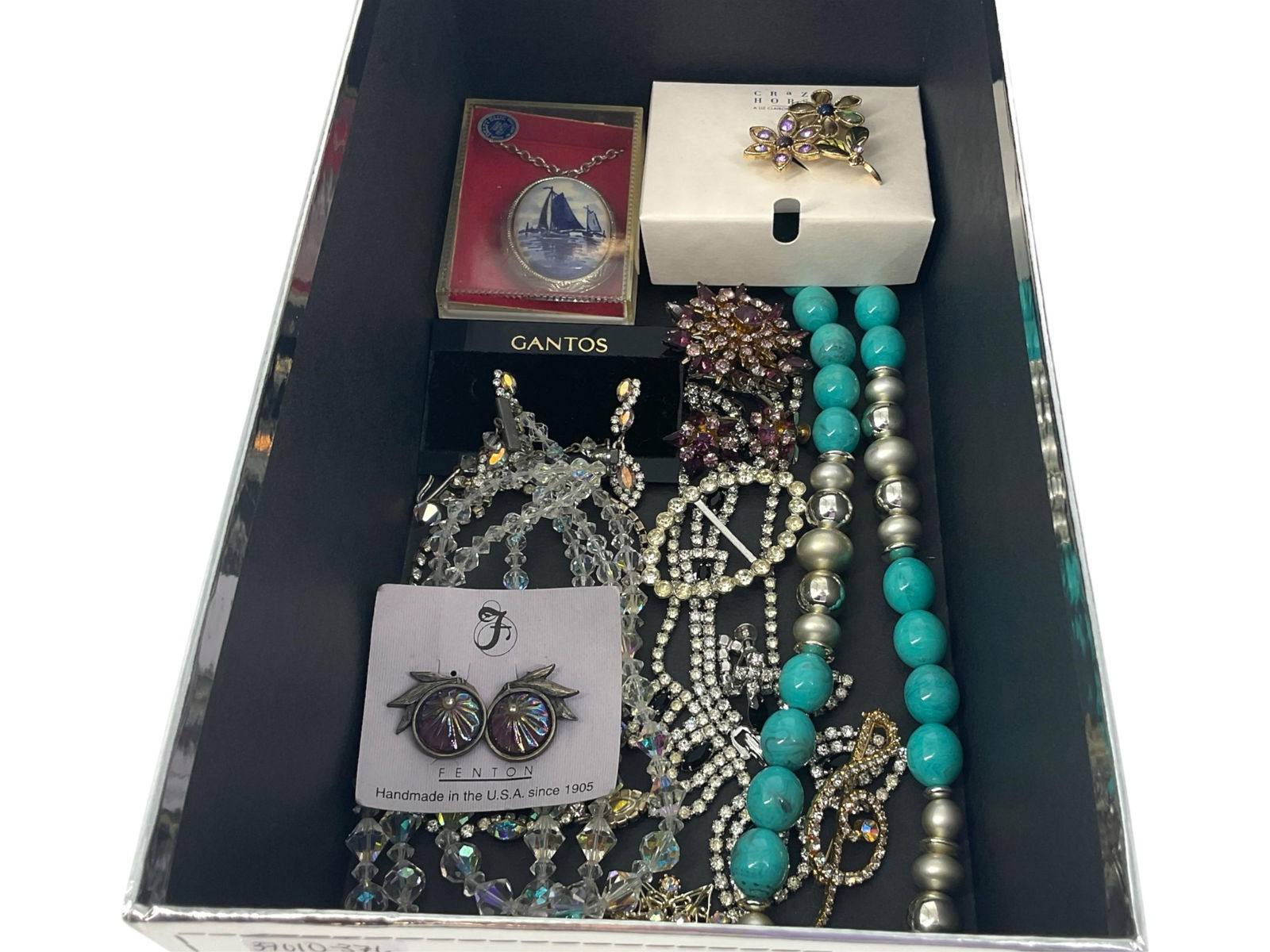 Box of Fashion Jewelry Including Fenton Glass Earrings, Iridescent Crystal Pieces, Delft Locket from: Box of Fashion Jewelry Including Fenton Glass Earrings, Iridescent Crystal Pieces, Delft Locket from Holland, "Coro" Fashion Crystal Set and MoreLot has a pair of clip-back vintage earrings with purpl