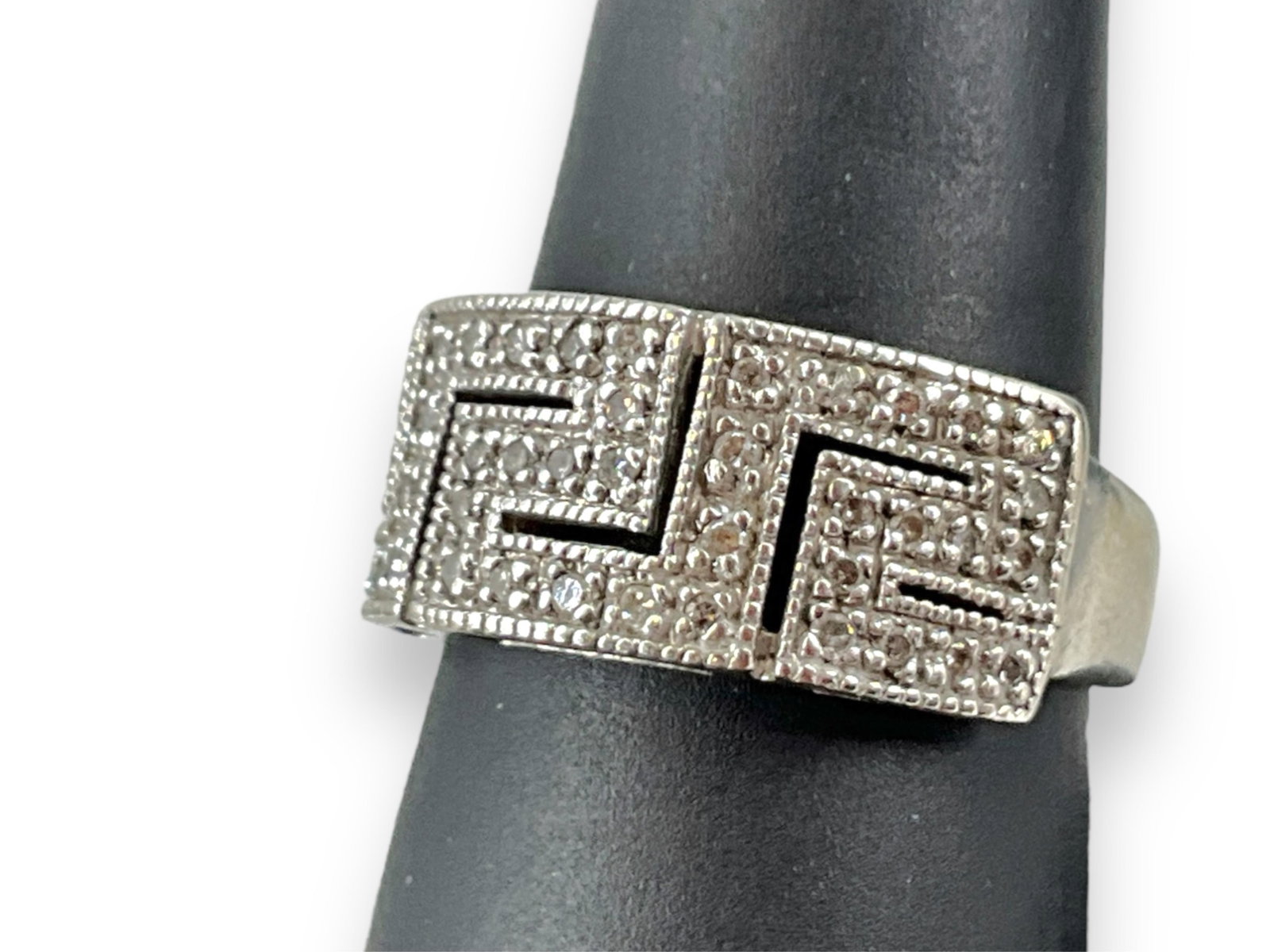 Sterling Silver & Diamond Ring: Sterling Silver & Diamond Ring Size (9) tapered shank ring with an openwork Greek key design, adorned with melee size diamonds, stamped and tested (0.18 troy oz tw).