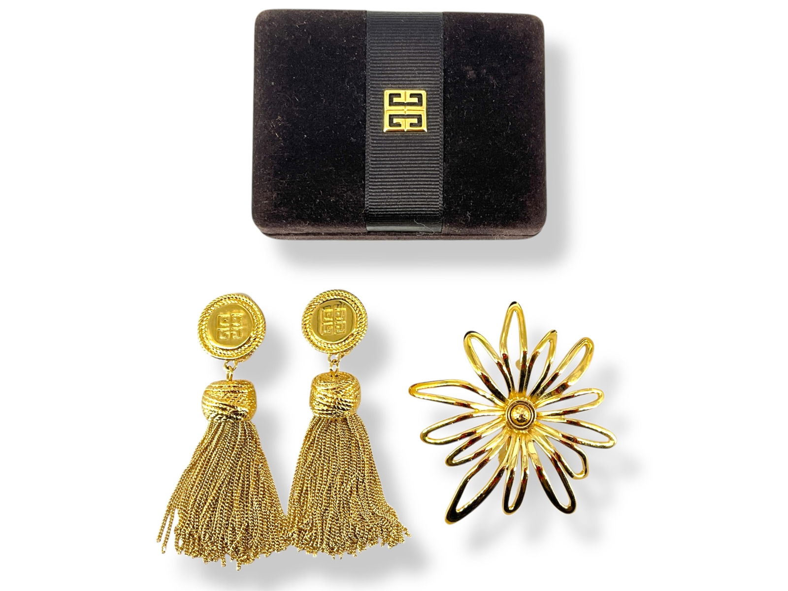 Givenchy Brooch & Earrings in Givenchy Box: Givenchy Brooch & Earrings in Givenchy BoxIn an included, branded "Givenchy" box is a gold-tone brooch hallmarked "Givenchy" which resembles a floral bloom and is approx 3" at the tallest, and also a