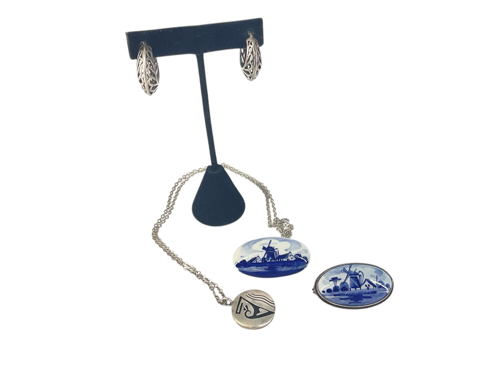 Two Delft Porcelain Brooches, Silver Hoop Earrings and Silver Southwest Necklace: Two Delft Porcelain Brooches, Silver Hoop Earrings and Silver Southwest Necklace Two porcelain delft pins include one with a tested silver frame having a windmill scene, brooch has a mark on the back 
