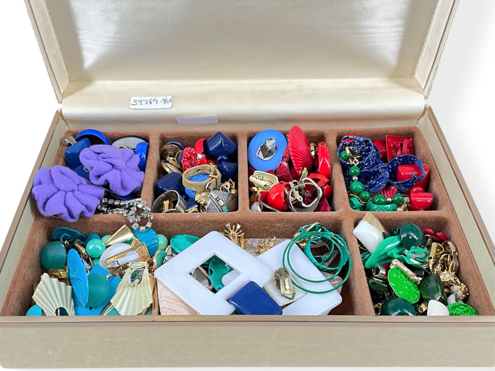 Vintage Jewelry Box with Over 25 Pair of Vintage Clip-Back Earrings: Vintage Jewelry Box with Over 25 Pair of Vintage Clip-Back Earrings Older jewelry box is approx 9" wide, 2 3/4" tall and 6" deep, box is covered in a cream MoirÈ fabric, shows age related wear. Box c