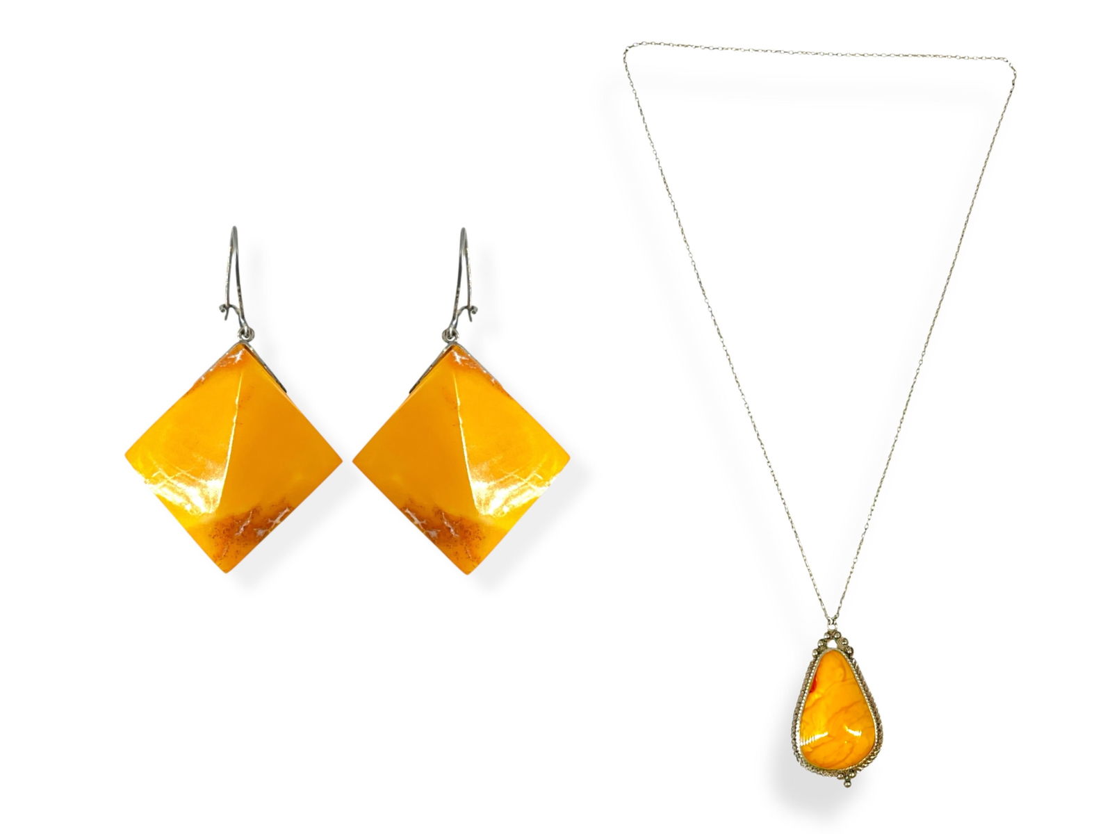 Cool Amber Necklace and Earrings: Cool Amber Necklace and EarringsAmber necklace is made in silver-tone metal, the chain is approx 28î long. The attached pendant is approx 2 1/2î tall and the pear-shaped butterscotch amber piece is