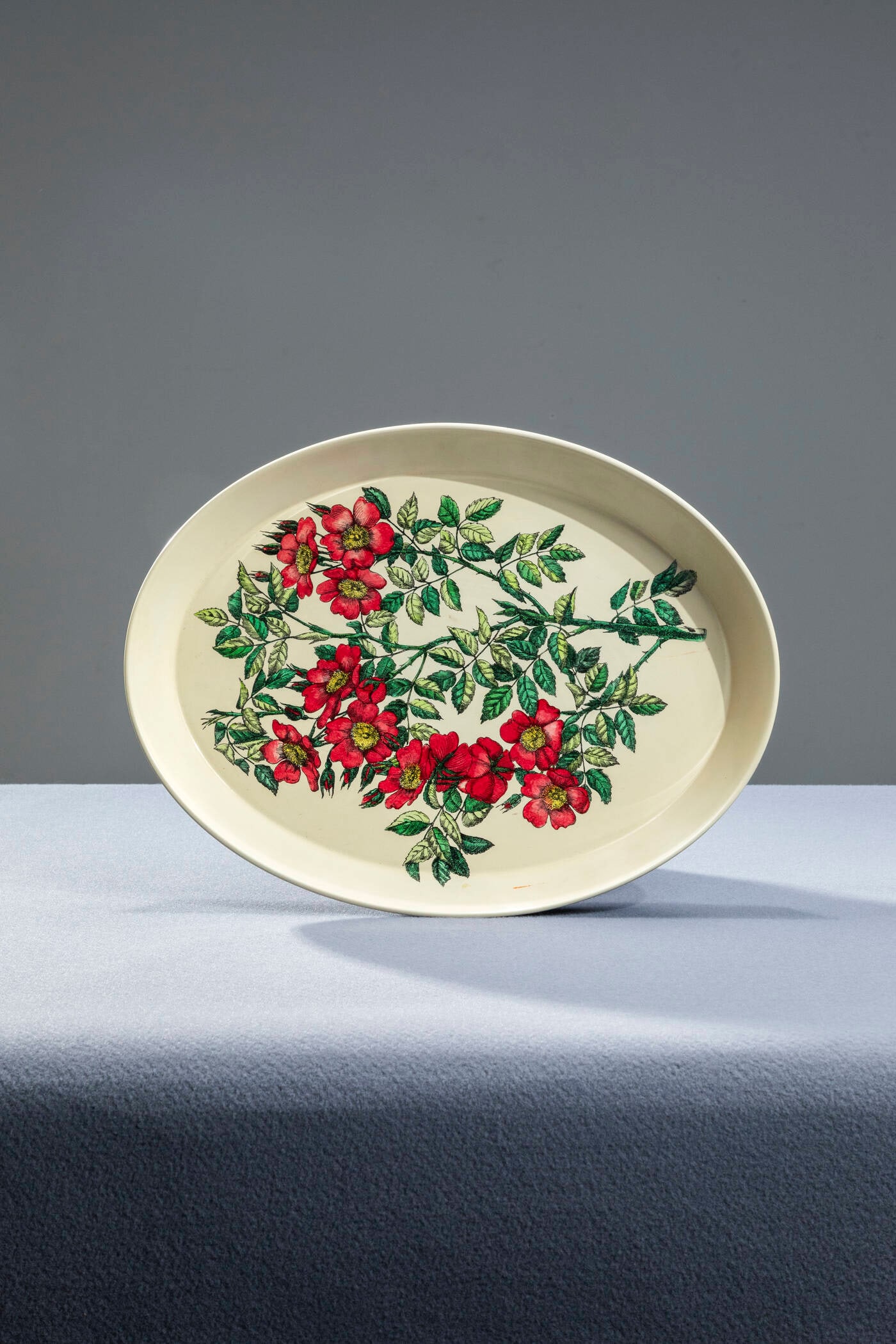 PIERO FORNASETTI: PIERO FORNASETTI Milano 1913 - 1988 Oval tray Silk-screened metal. Manufacturer's label 1960s cm 4x45 Defects