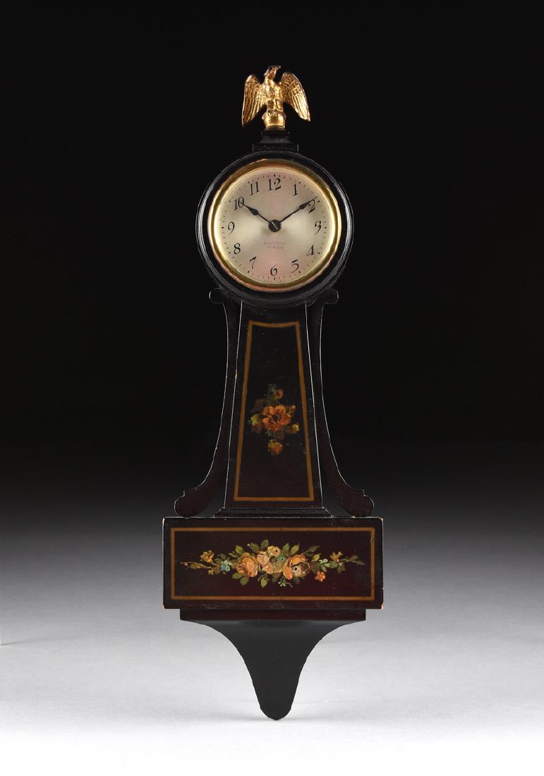 A SETH THOMAS BLACK LACQUERED WOOD "BLACKSTON" CLOCK,: A SETH THOMAS BLACK LACQUERED WOOD "BLACKSTON" CLOCK, THOMASTON, CONNECTICUT, CIRCA 1930, the banjo form clock with painted floral decoration on black lacquered wood body surmounted by a gilt metal ea