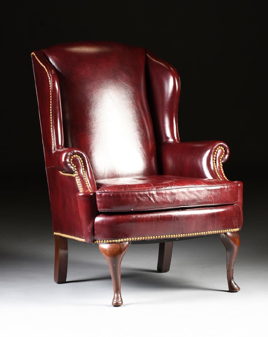 A HANCOCK & MOORE LEATHER UPHOLSTERED MAHOGANY WING: A HANCOCK & MOORE LEATHER UPHOLSTERED MAHOGANY WING BACK CHAIR, HICKORY, NORTH CAROLINA, LATE 20TH CENTURY, of typical form with turned mahogany cabriole pad footed legs to the front and square sectio