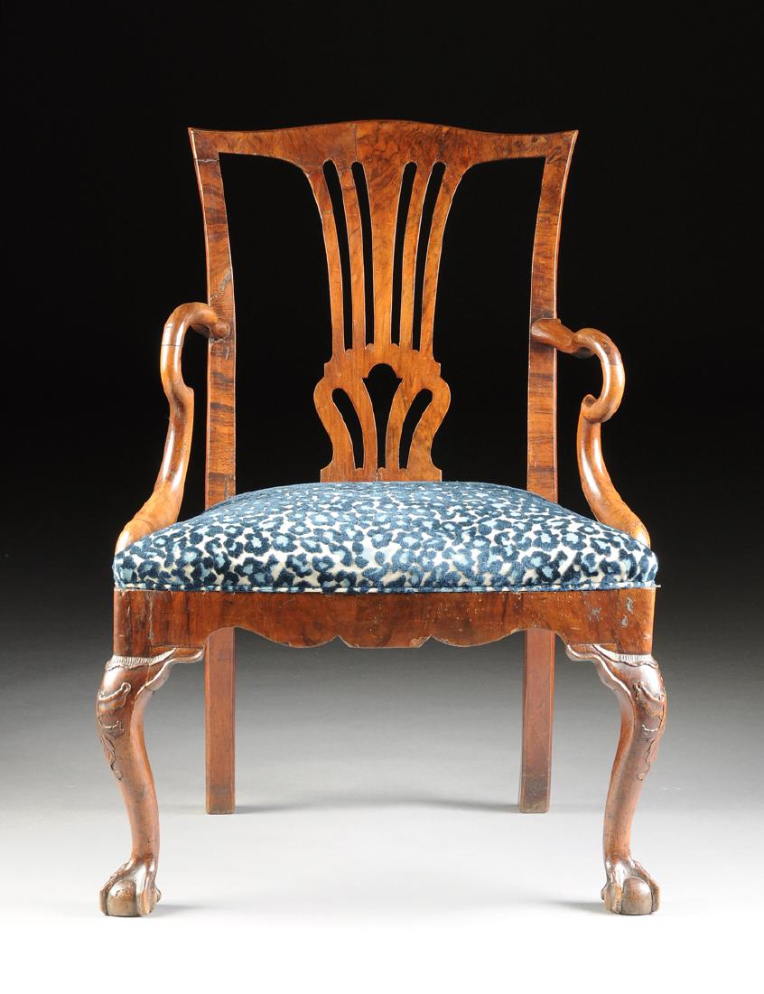 A DUTCH GEORGE III WALNUT AND MAHOGANY OPEN ARMCHAIR,: A DUTCH GEORGE III WALNUT AND MAHOGANY OPEN ARMCHAIR, LATE 18TH CENTURY, in the manner of Thomas Chippendale (English 1718-1779), the subtly shaped crest rail over a walnut veneered central baluster f