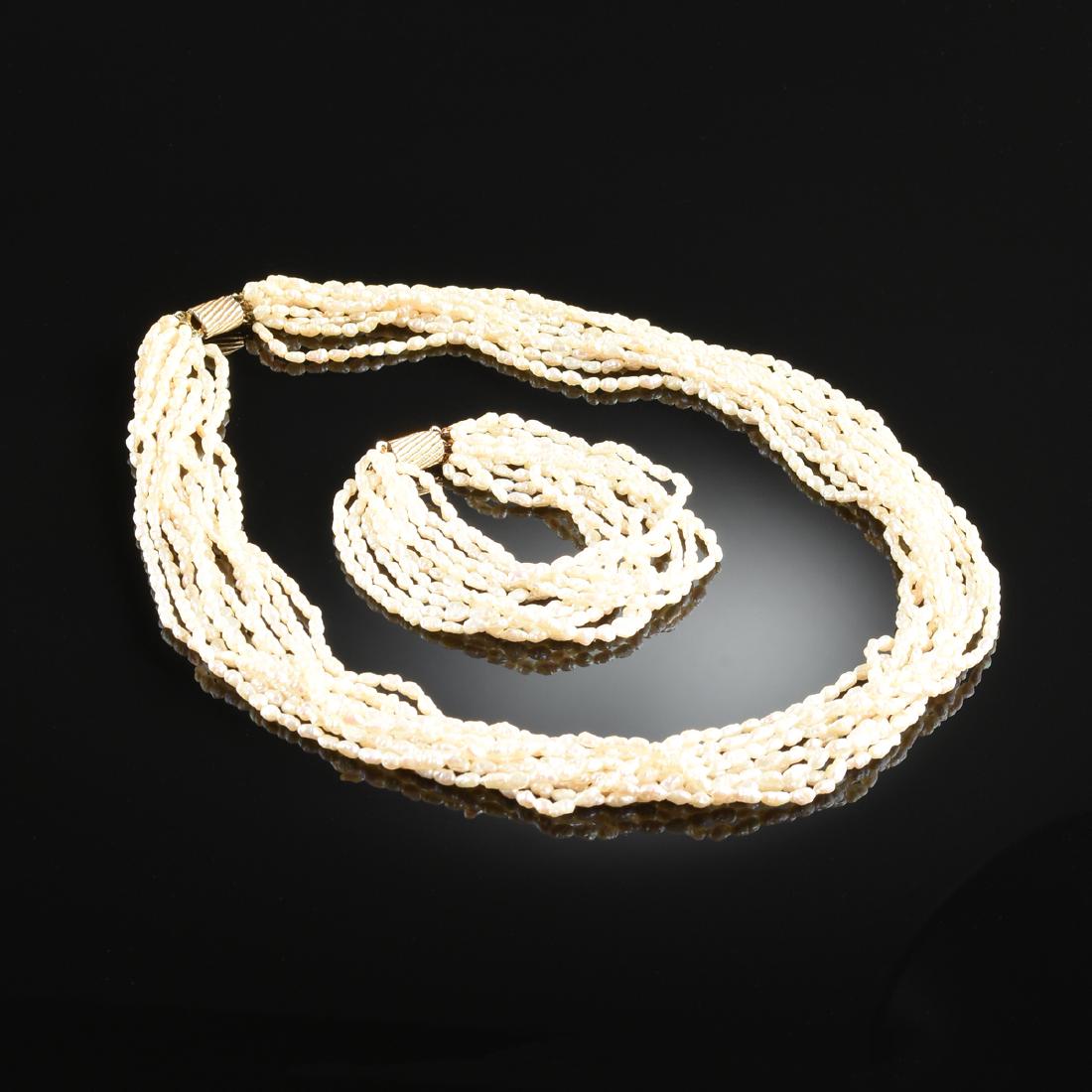 A SEED PEARL NECKLACE WITH MATCHING BRACELET,: A SEED PEARL NECKLACE WITH MATCHING BRACELET, the necklace comprising ten strands of seed pearls, joined by a gold tone casket formed fastener, the bracelet comprising ten strands of seed pearls, join