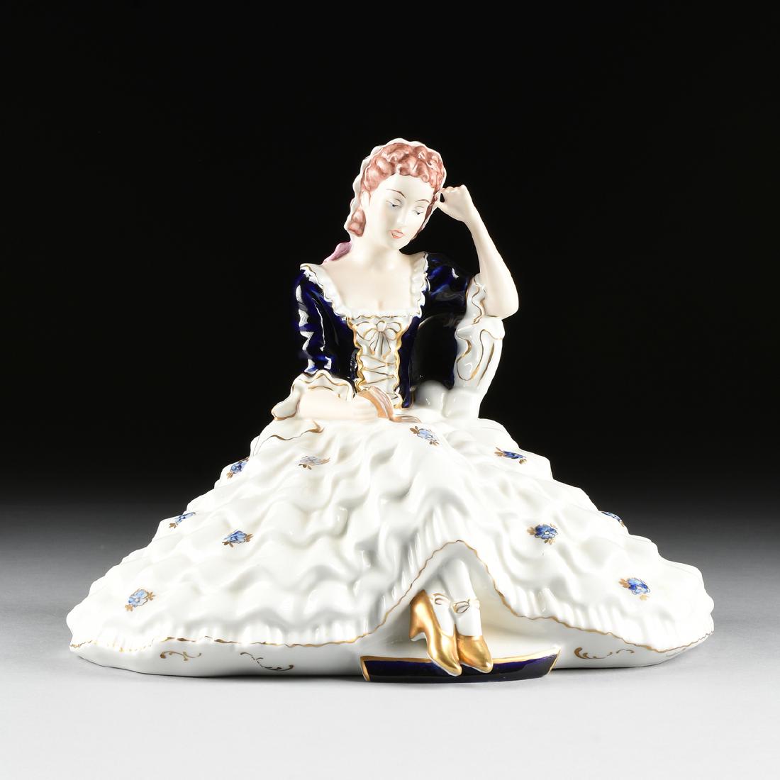 A ROYAL DUX (DUCHCOVSKY) PORCELAIN HAND PAINTED FIGURE: A ROYAL DUX (DUCHCOVSKY) PORCELAIN HAND PAINTED FIGURE OF A SEATED WOMAN, DUCHOV, CZECHOSLOVAKIA, CIRCA 1946-1970, the figure of a woman wearing a billowing white crinoline skirt with scattered floral