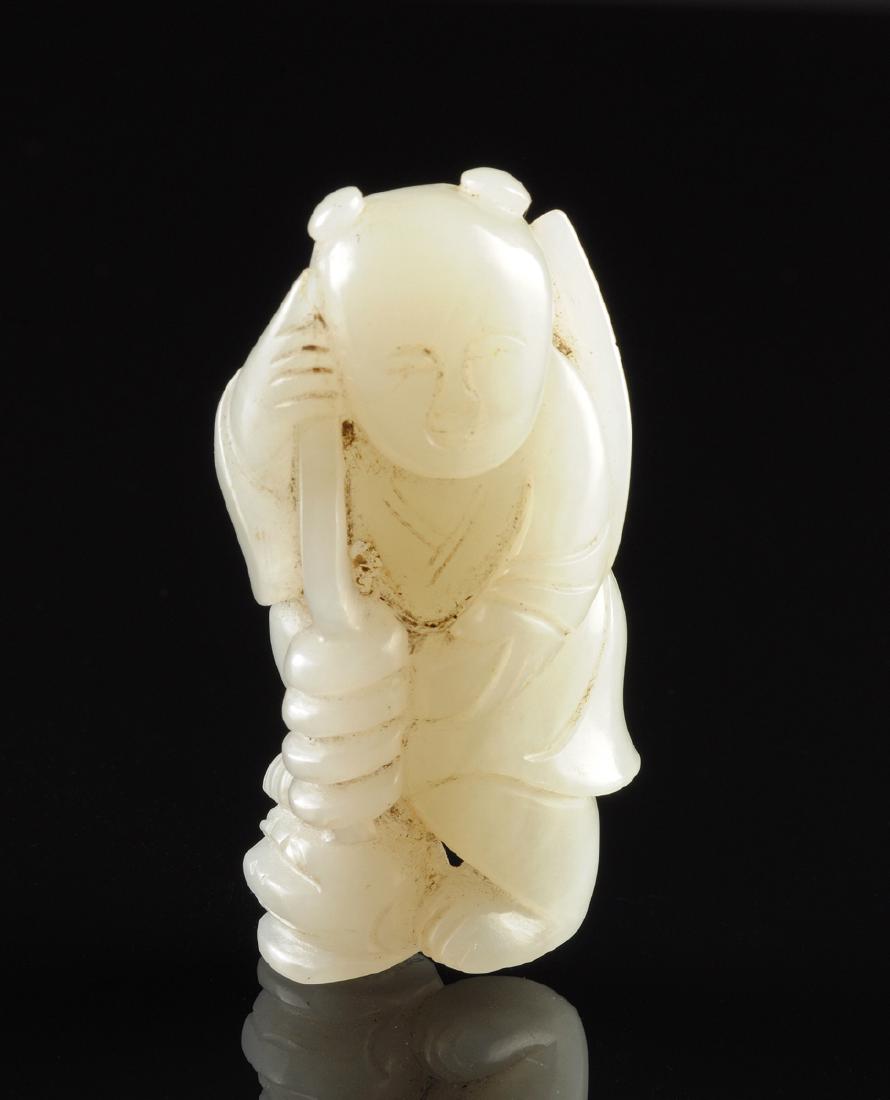A CHINESE CARVED WHITE JADE FIGURAL GROUP OF A YOUTH (1 of 4)