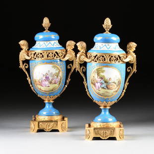 A PAIR OF SÈVRES STYLE BRONZE DORÉ MOUNTED BLUE: A PAIR OF SÈVRES STYLE BRONZE DORÉ MOUNTED BLUE PORCELAIN COVERED POTPOURRI URNS, LATE 19TH CENTURY, PROBABLY FRENCH, WITH SCENES AFTER JEAN ANTOINE WATTEAU (1684-1721), the pineapple and acanthus l