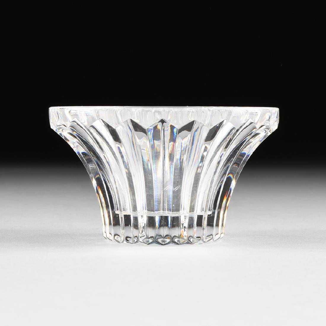 A BACCARAT CLEAR CRYSTAL CANDLE HOLDER, FRANCE, LATE: A BACCARAT CLEAR CRYSTAL CANDLE HOLDER, FRANCE, LATE 20TH CENTURY, of flaring waisted form with cut ribs, acid etched manufacturer's mark. Height: 2 1/2" Diameter: 4 1/4"