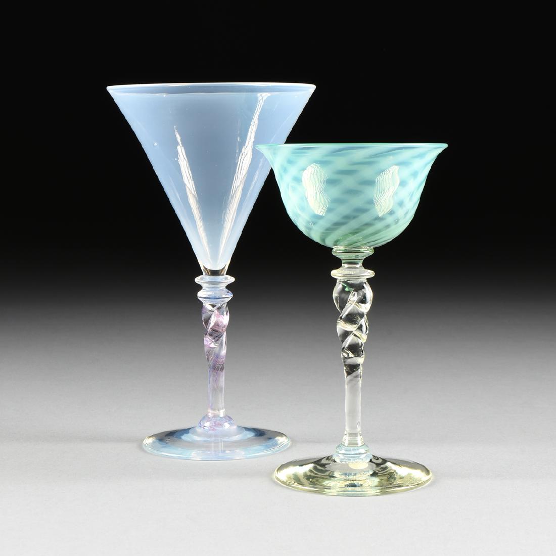 FREDERICK CARDER (British/American 1863-1963) A GROUP: FREDERICK CARDER (British/American 1863-1963) A GROUP OF TWO COLORED WINE GLASSES, FOR STEUBEN, CORNING, NEW YORK, CIRCA 1920-1930, comprising a wine stem in Verre de Soie iridescent pale amethyst gla