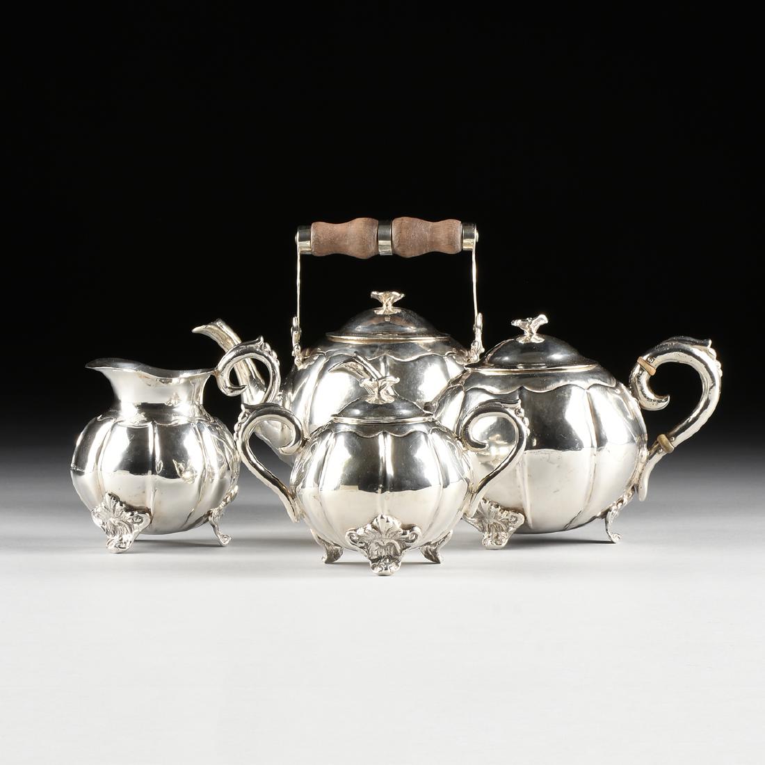A FOUR PIECE SOUTH AMERICAN 900 STANDARD SILVER TEA: A FOUR PIECE SOUTH AMERICAN 900 STANDARD SILVER TEA SERVICE, PROBABLY CHILE, LATE 19TH CENTURY, of lobed ovoid form, comprising a small hot water kettle with turned wooden swing handle, lid with folia