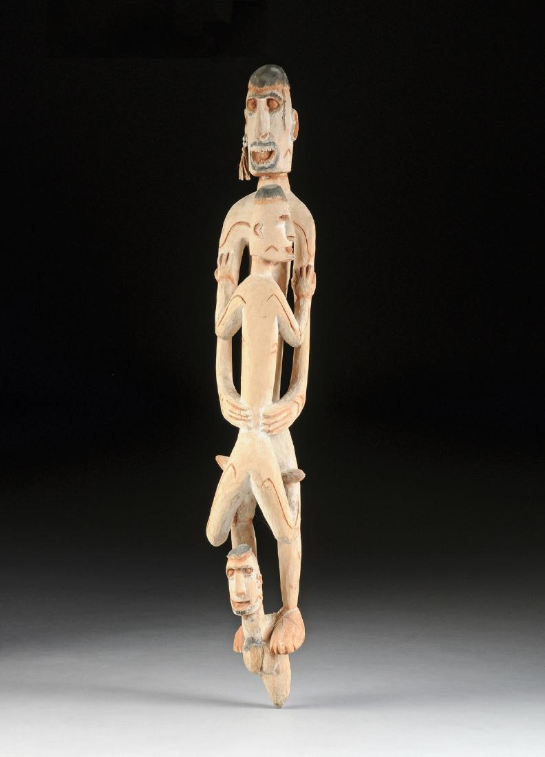 AN INDONESIAN TRIBAL PAINTED AND CARVED WOOD FIGURAL (1 of 11)