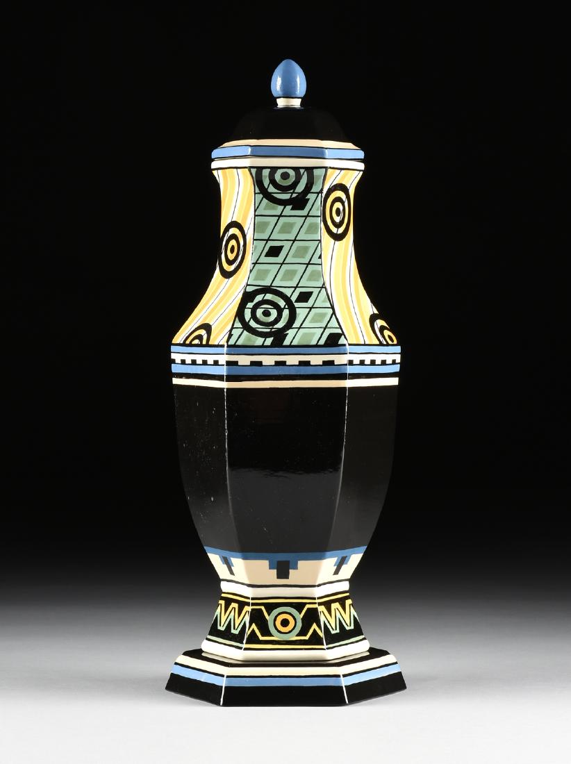 A BRIAN OVERLY GLAZED PORCELAIN COVERED VASE WITH: A BRIAN OVERLY GLAZED PORCELAIN COVERED VASE WITH STAND, DALLAS, TEXAS, 1981, of hexagonal baluster form, with alternating panels of geometric decoration on the neck over dark blue body, the foot with
