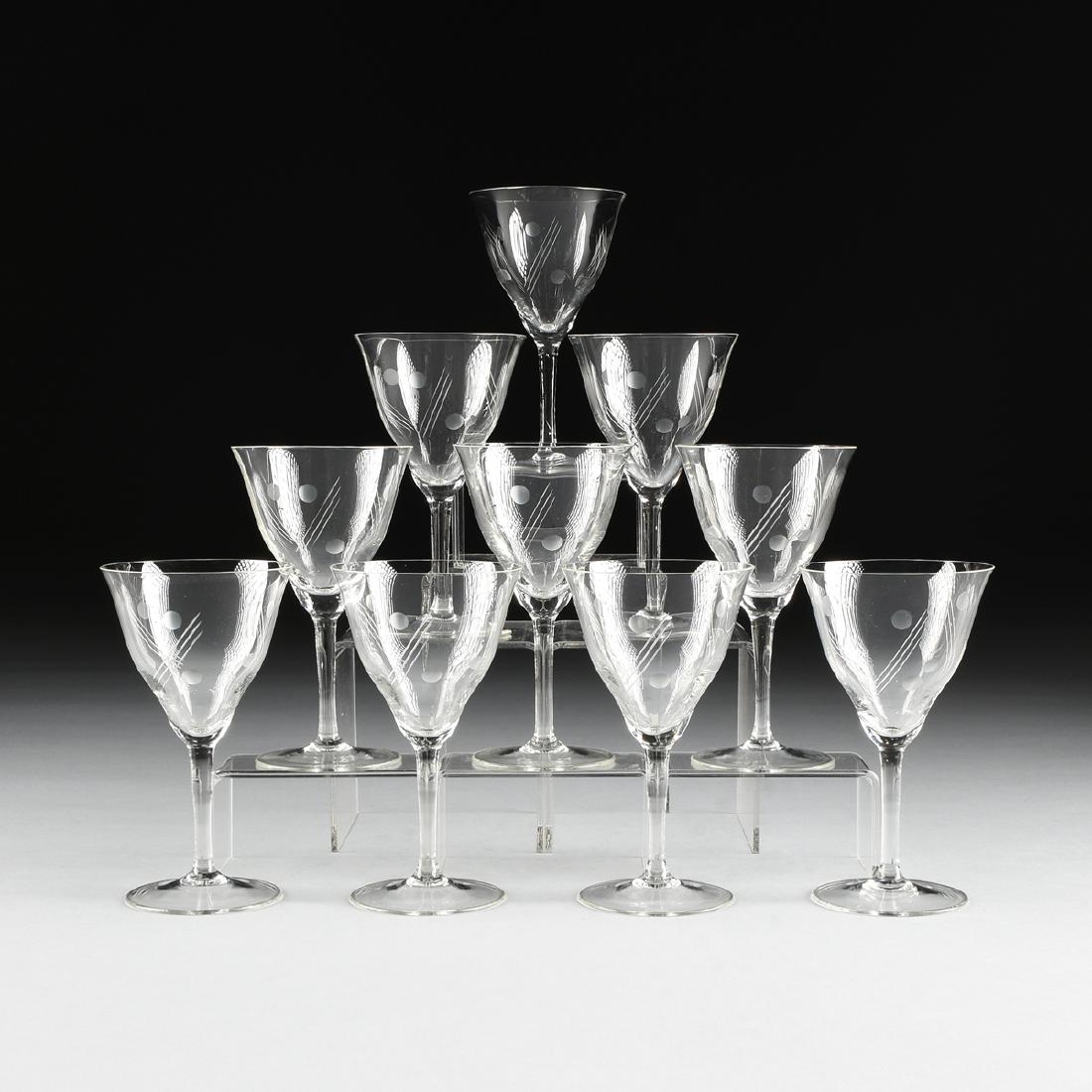A SET OF TEN CANARY YELLOW DEPRESSION GLASS ETCHED: A SET OF TEN CANARY YELLOW DEPRESSION GLASS ETCHED WHITE WINE GLASSES, CIRCA 1940, the everted lip bell shape bowl raised on slightly waisted stem and spreading foot, with etched dot and line decorati