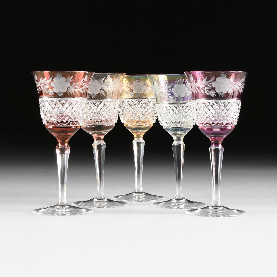 A GROUP OF FIVE BOHEMIAN CASED, ETCHED, AND CUT CRYSTAL: A GROUP OF FIVE BOHEMIAN CASED, ETCHED, AND CUT CRYSTAL WINE GLASSES, CIRCA 1980, the colored crystal glasses with etched band of floral sprays at the rim over cut diamonds, raised on tapering hexagon